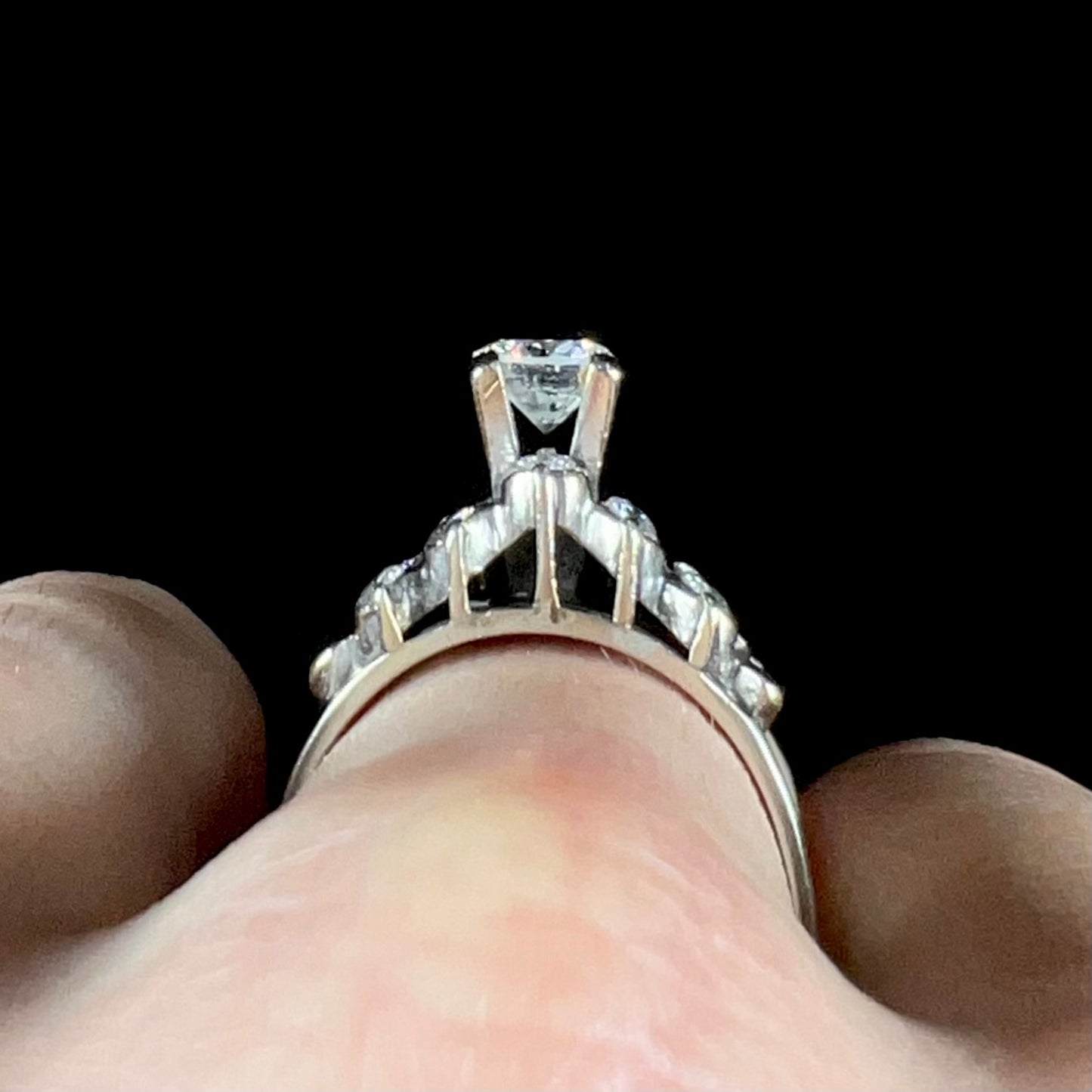 A vintage, 1940's style white gold diamond wedding ring set with a 0.68ct round diamond. The diamond has a noticeable black crystal inclusion.