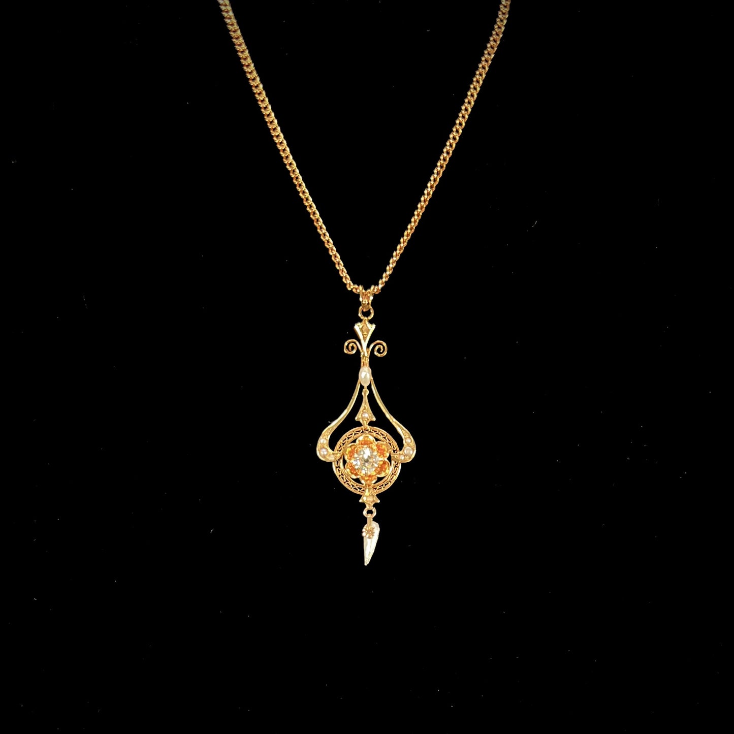 A ladies' Edwardian style gold necklace set with pearls and an old mine cut diamond. The chain is marked "1916".