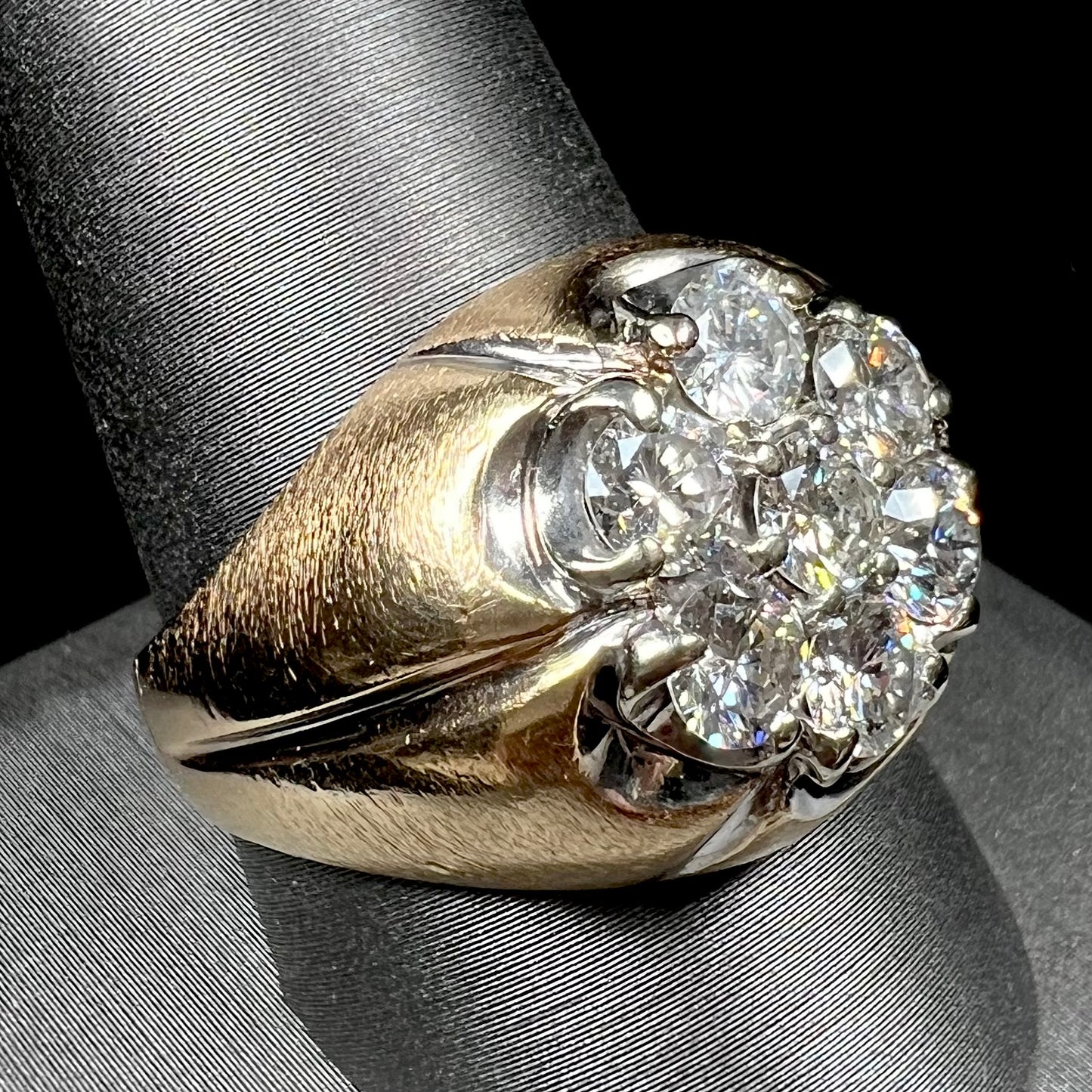 A men's textured yellow gold ring set with a cluster of seven round brilliant cut natural diamonds.