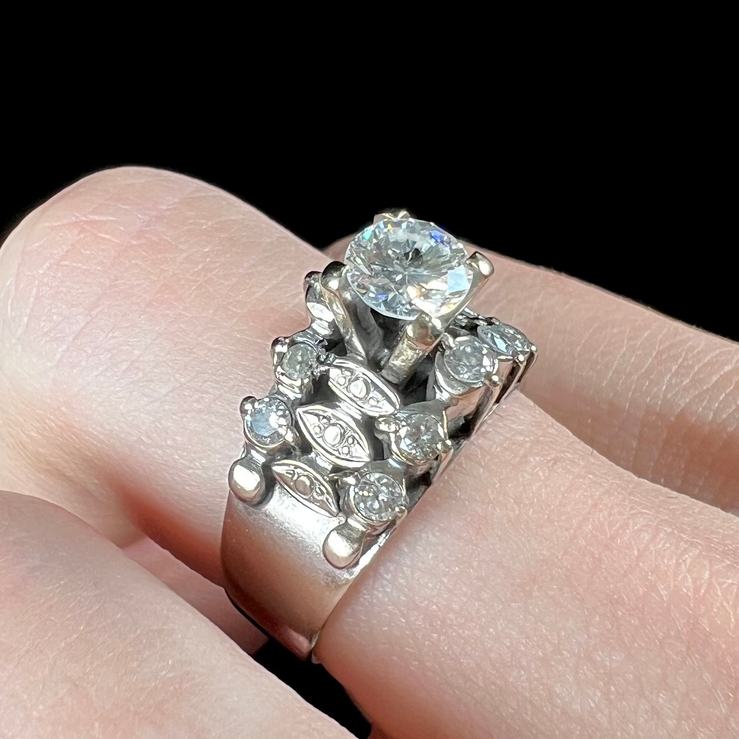 A vintage, 1940's style white gold diamond wedding ring set with a 0.68ct round diamond. The diamond has a noticeable black crystal inclusion.