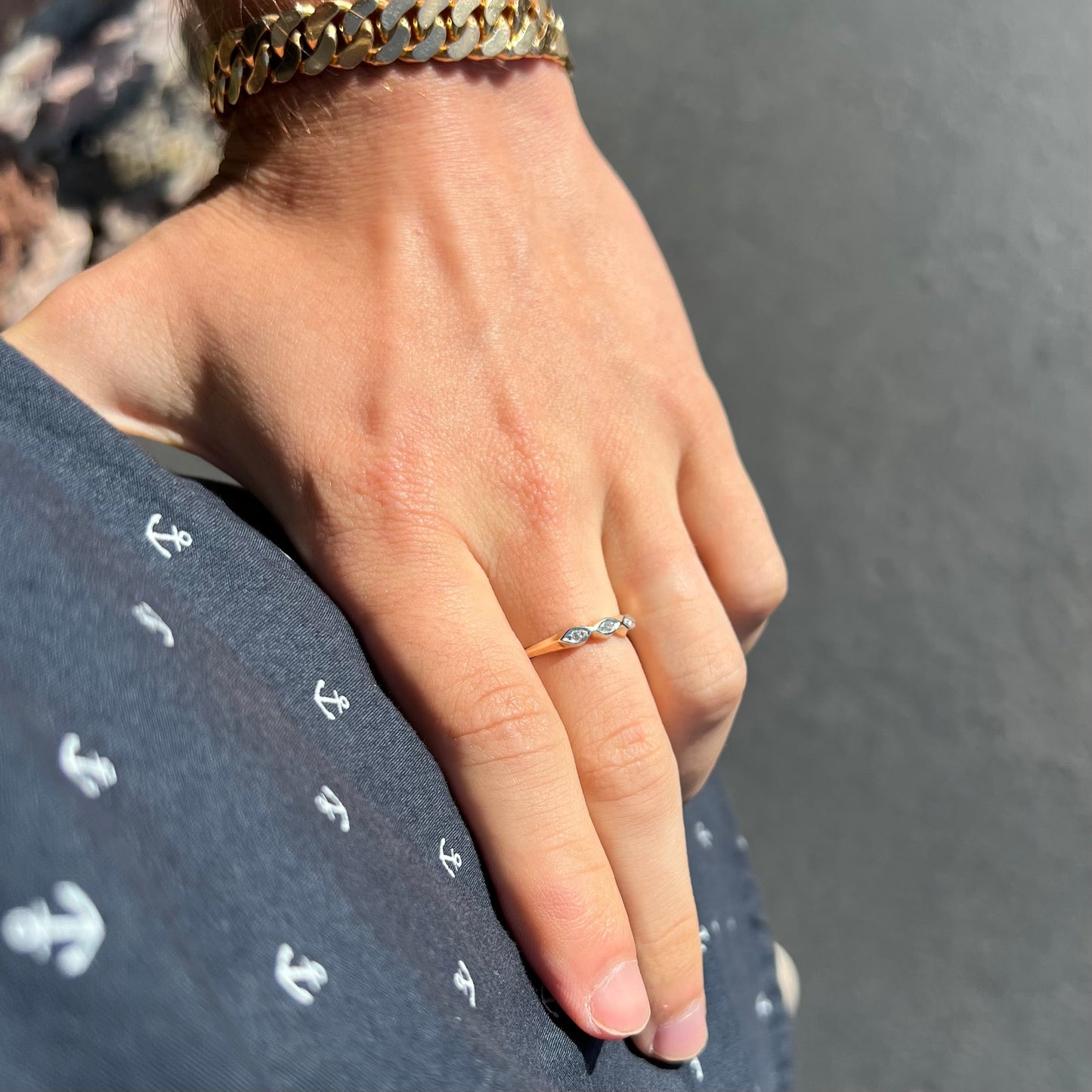 A vintage, yellow gold ladies' wedding band set with three single cut diamonds in marquise shaped designs.