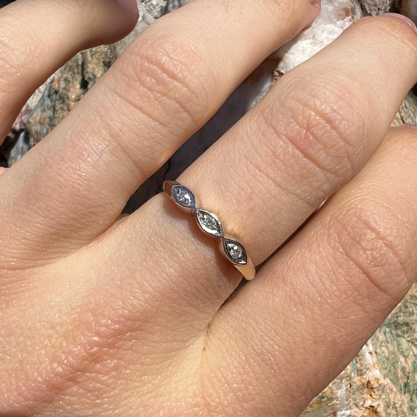 A vintage, yellow gold ladies' wedding band set with three single cut diamonds in marquise shaped designs.