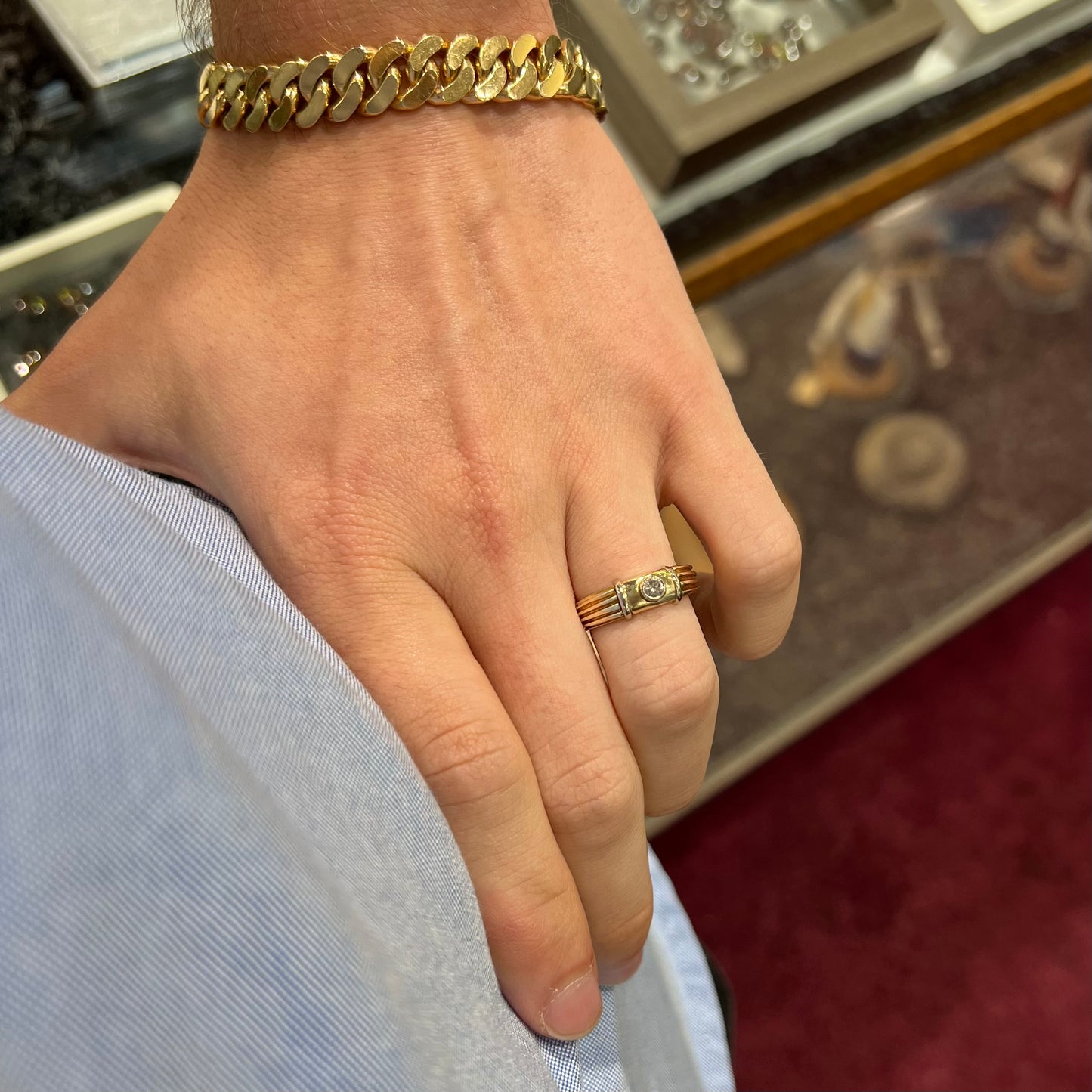A unisex, vintage style two tone yellow and white gold wedding ring bezel set with a round diamond.
