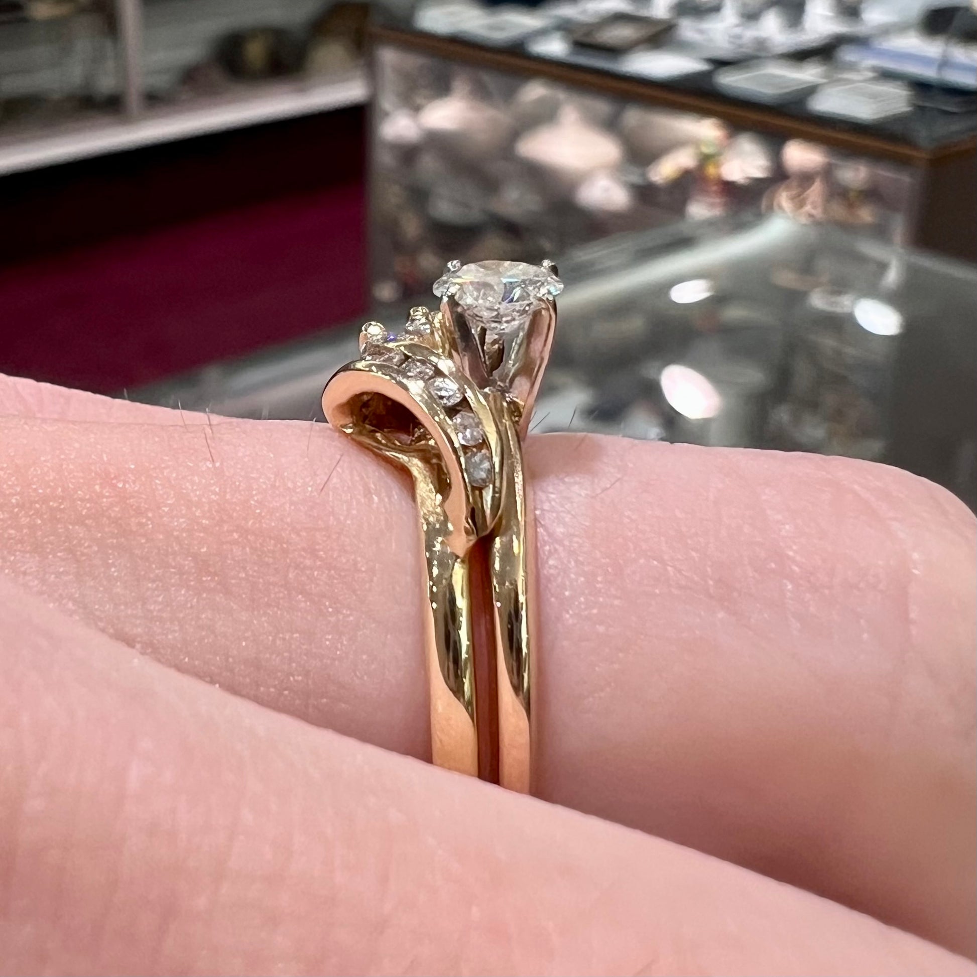 A vintage diamond wedding set with a round brilliant cut center stone and marquise cut accents in yellow gold.