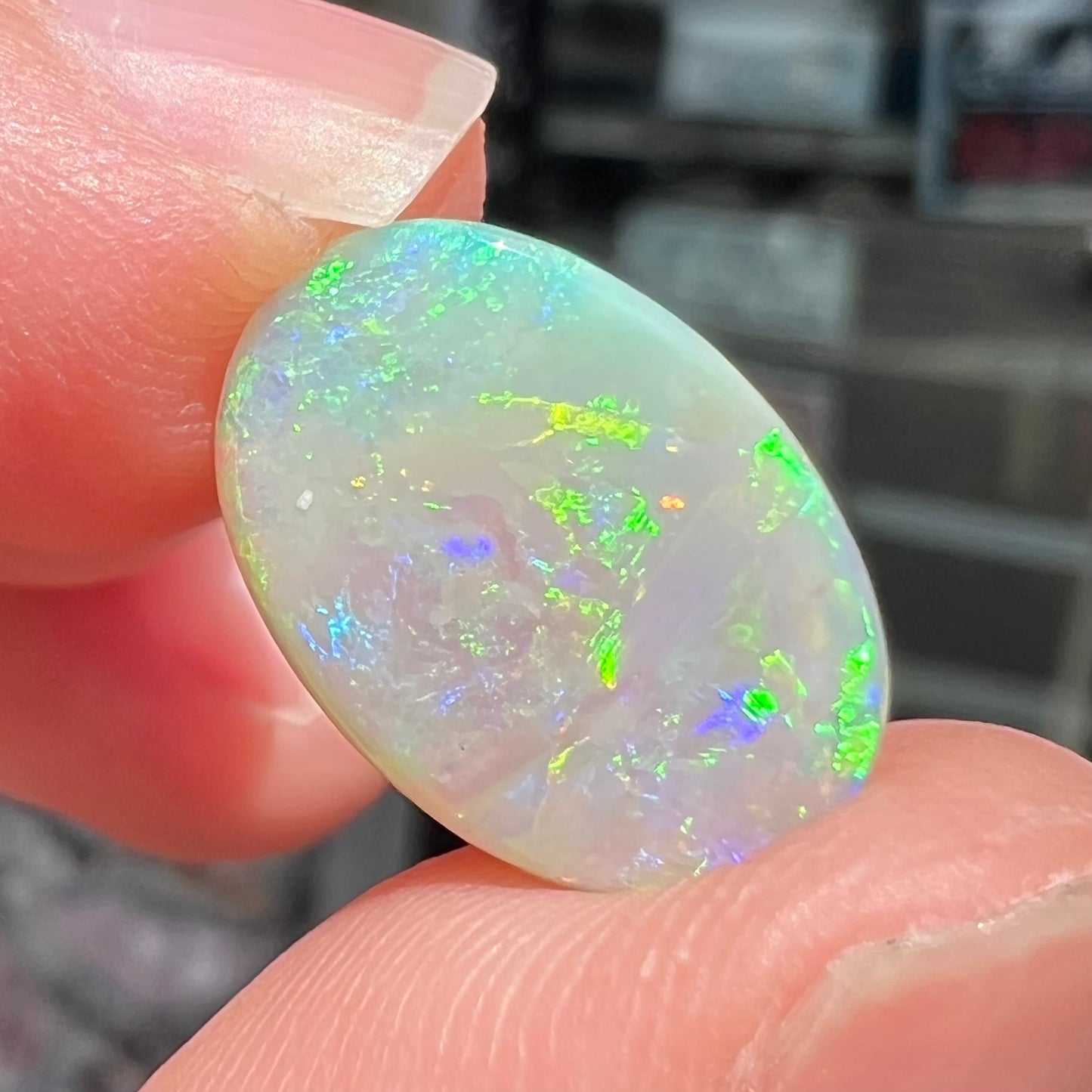 A double-sided opal stone from Coober Pedy, Australia. The opal plays green, blue, and orange colors from the front and the back.