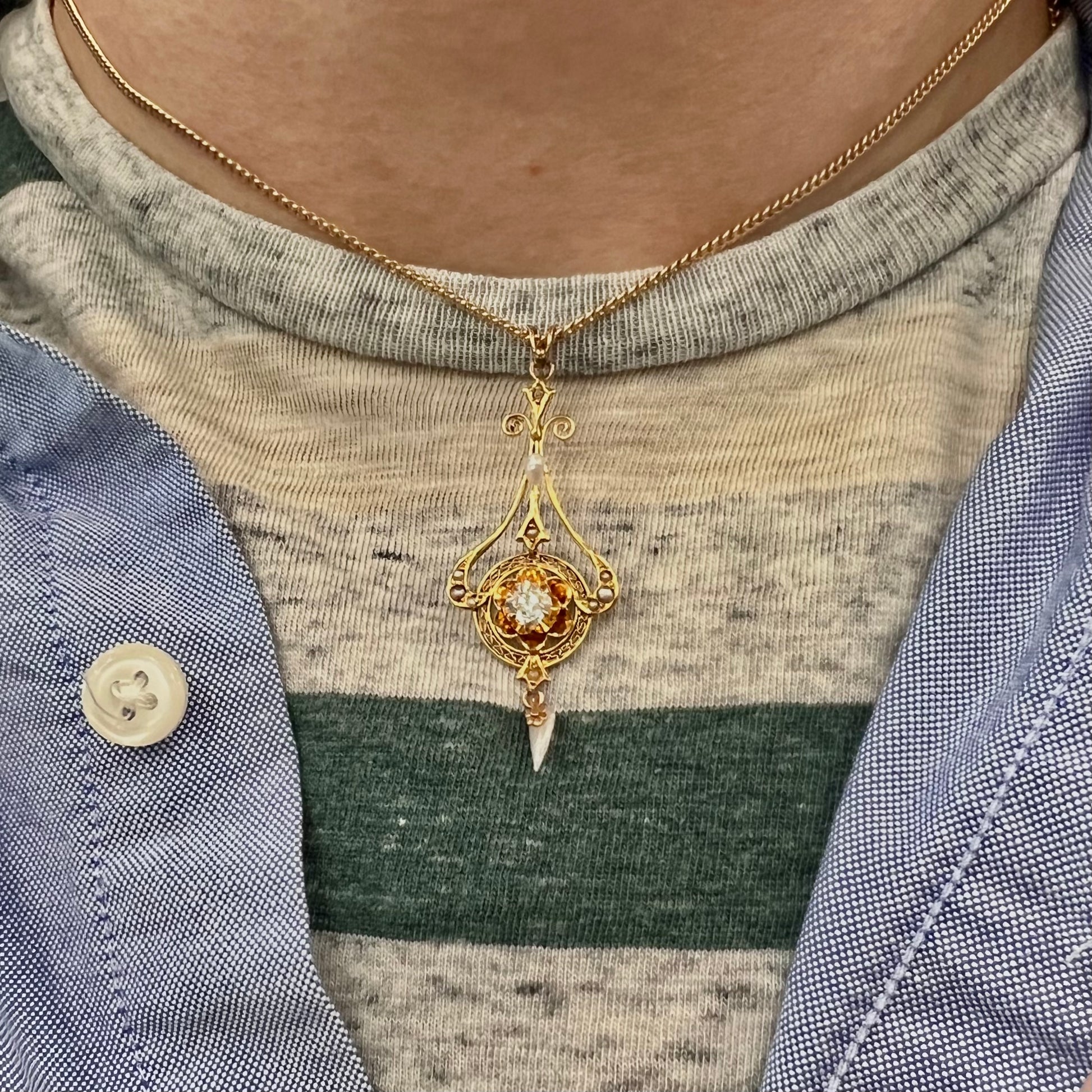 A ladies' Edwardian style gold necklace set with pearls and an old mine cut diamond.  The chain is marked "1916".