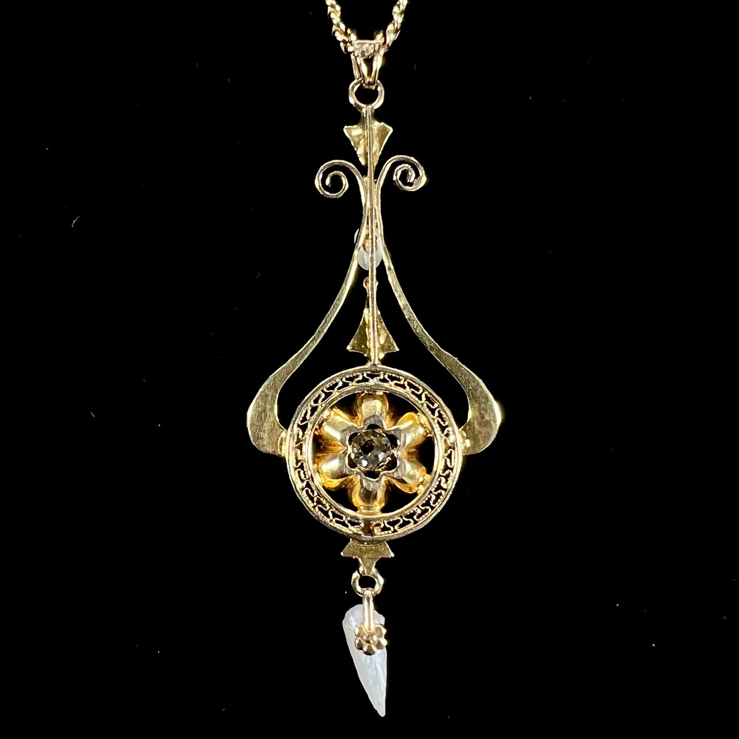 A ladies' Edwardian style gold necklace set with pearls and an old mine cut diamond. The chain is marked "1916".