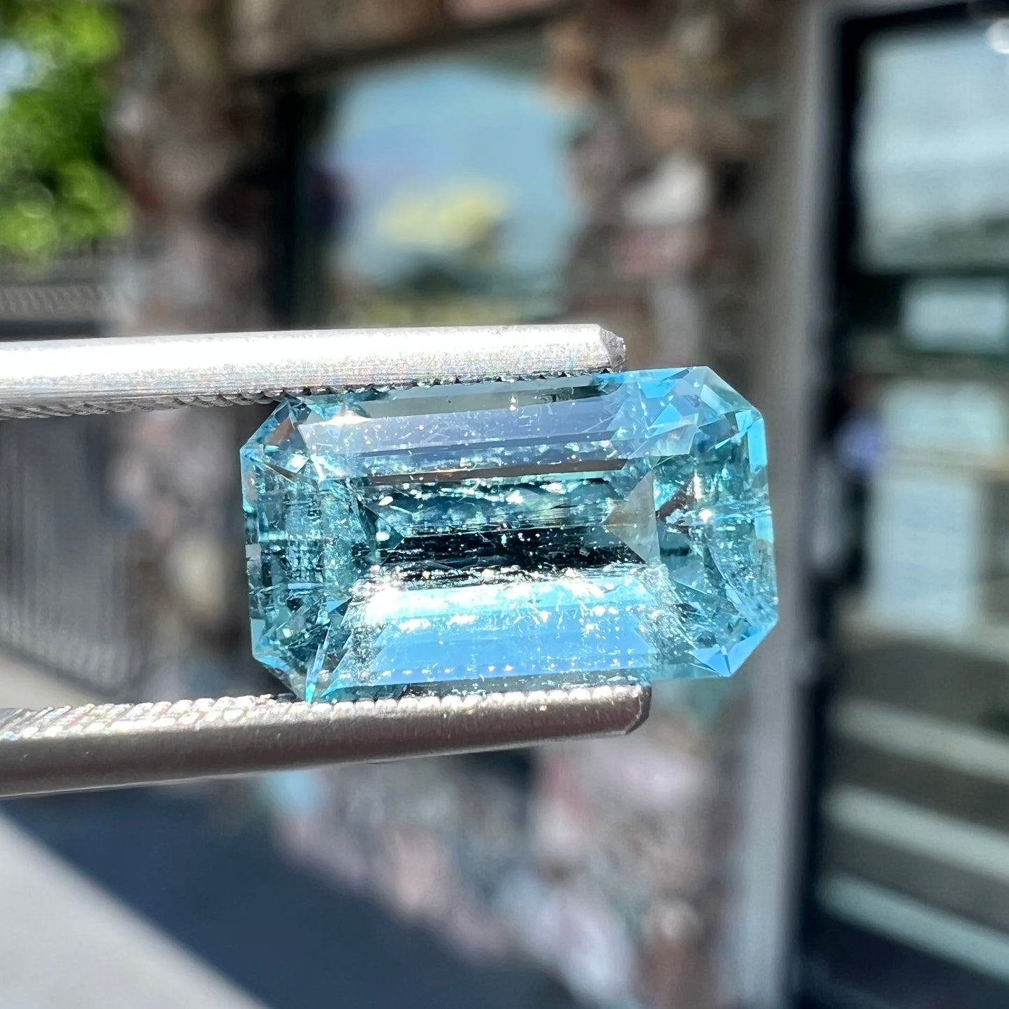 A loose, faceted emerald cut aquamarine stone. The stone is icy blue in color, indicative of Vietnamese origin.