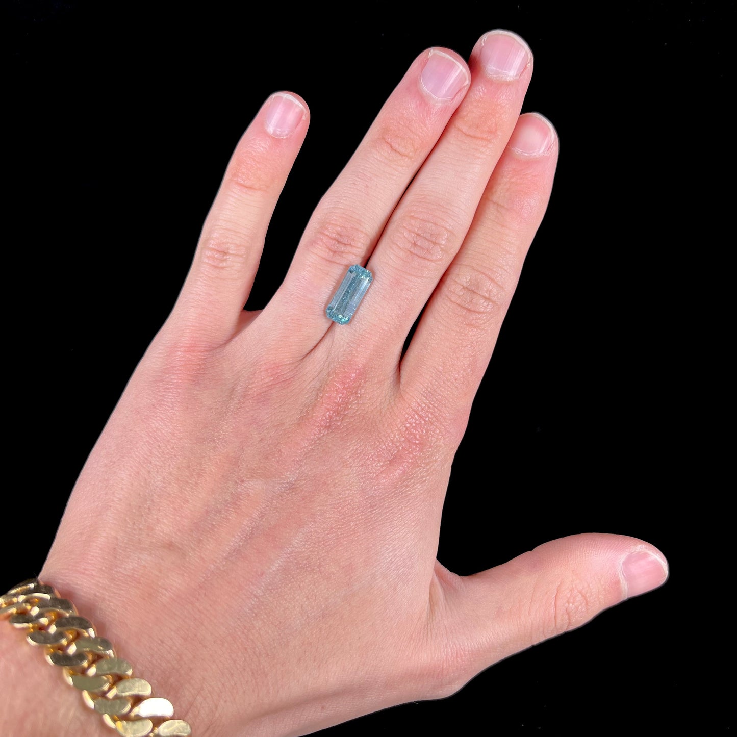 A loose, emerald cut aquamarine stone from Vietnam. The stone is an ice blue color.