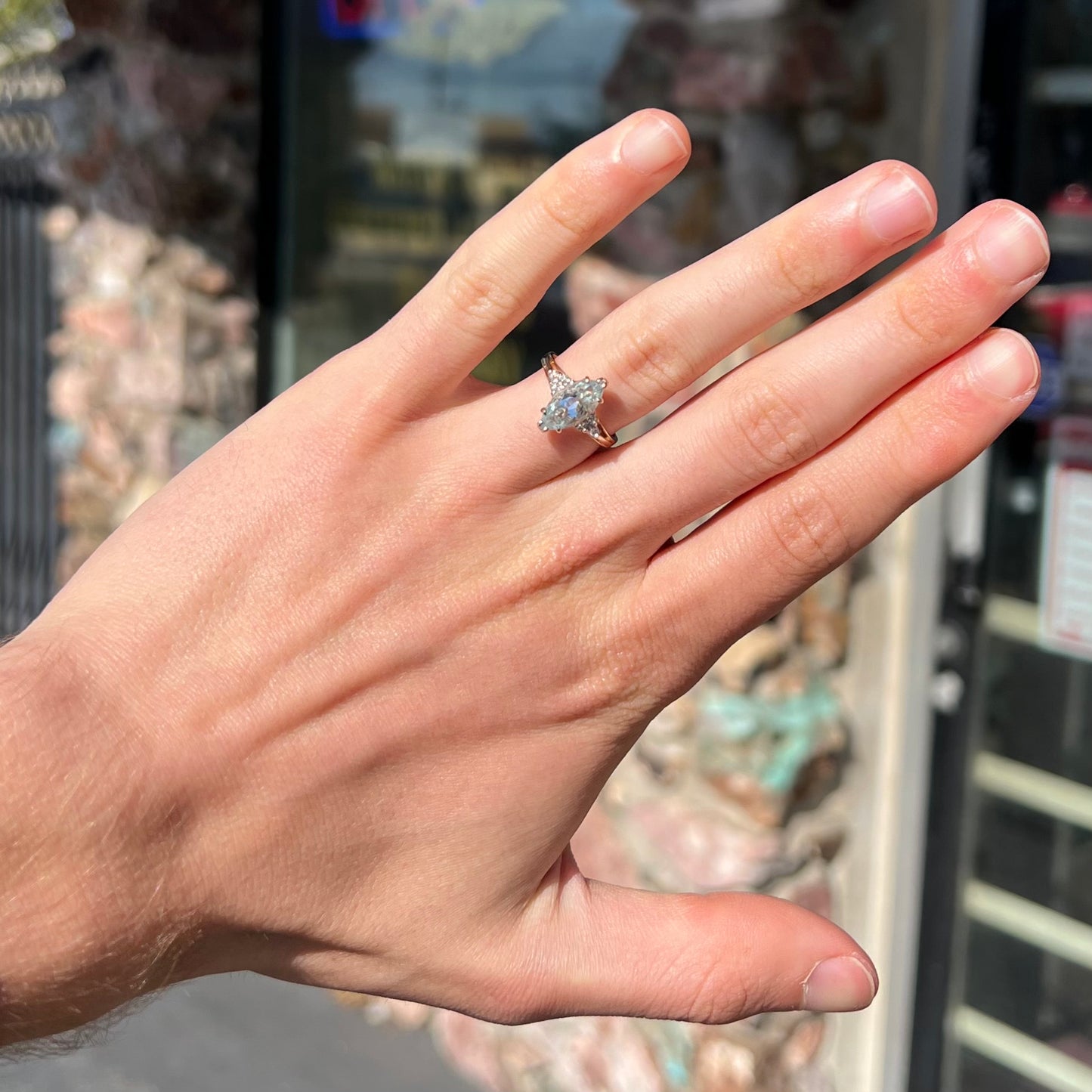 A ladies' ring set with a marquise cut aquamarine and round accent diamonds.