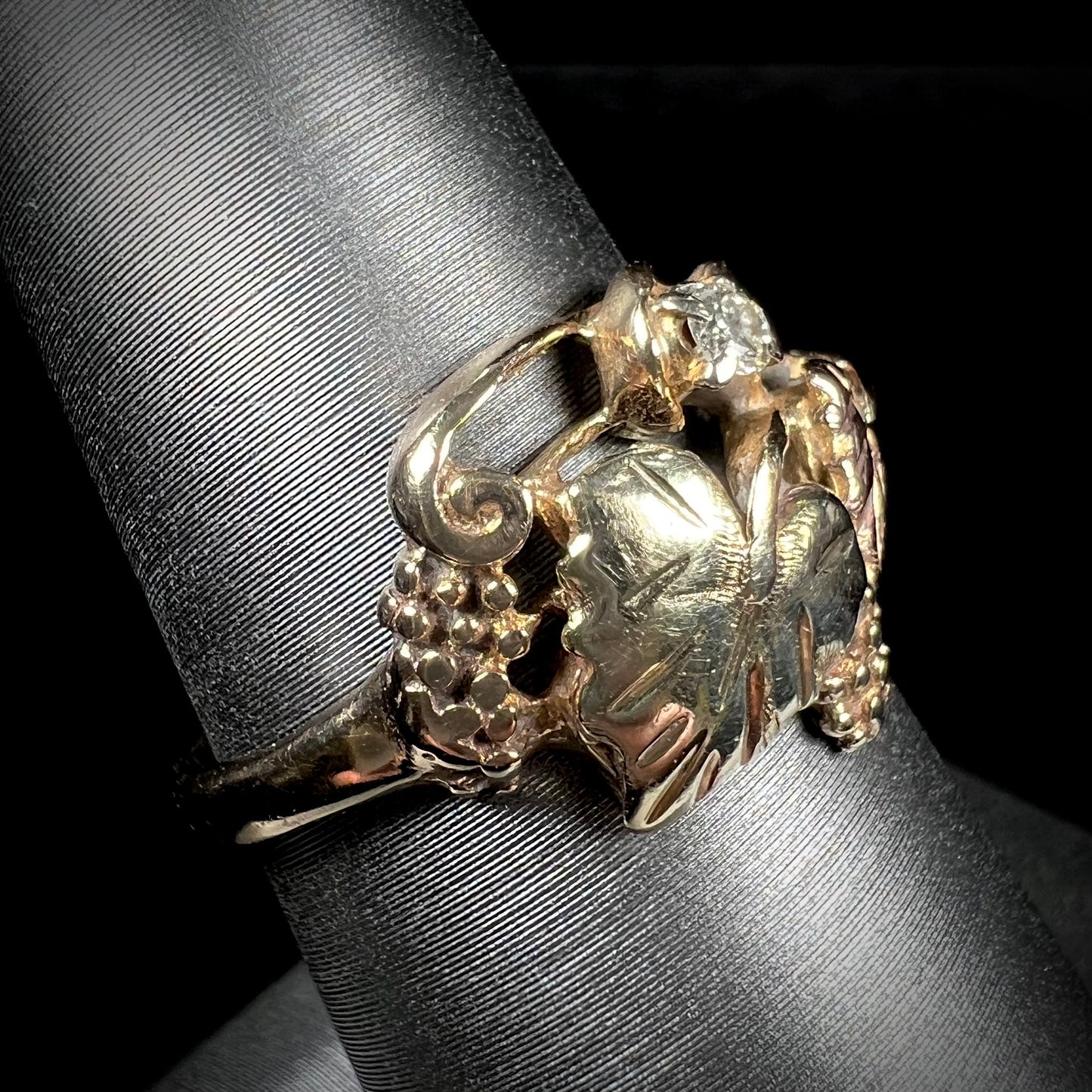 A ladies' two tone rose and yellow gold Black Hills gold diamond ring. The ring exhibits a leaf design.