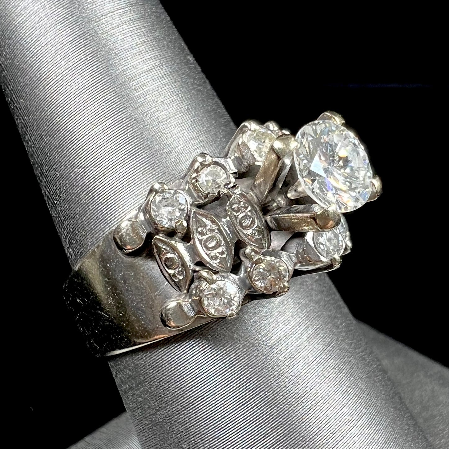 A vintage, 1940's style white gold diamond wedding ring set with a 0.68ct round diamond. The diamond has a noticeable black crystal inclusion.