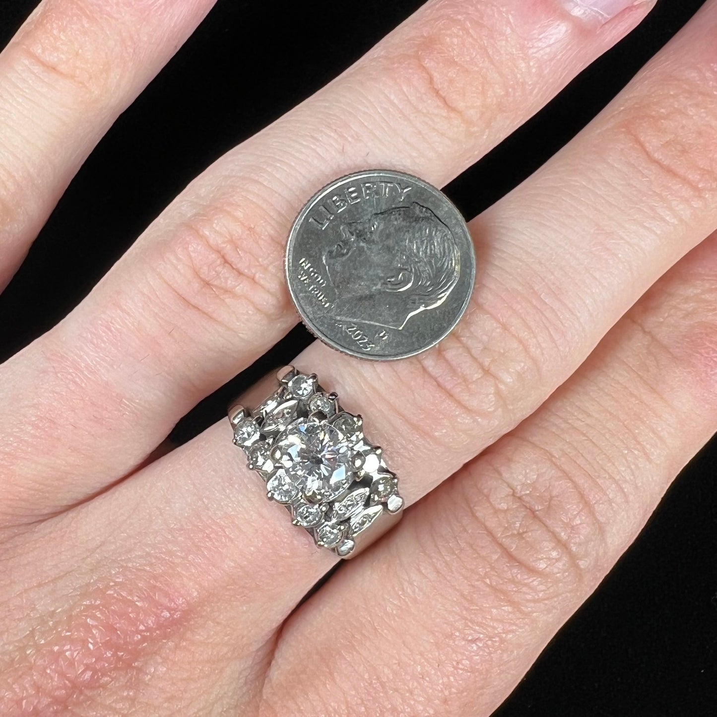 A vintage, 1940's style white gold diamond wedding ring set with a 0.68ct round diamond. The diamond has a noticeable black crystal inclusion.