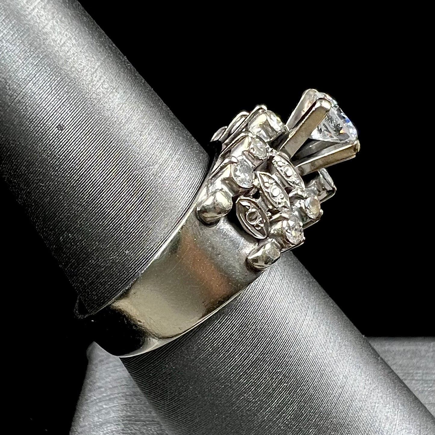 A vintage, 1940's style white gold diamond wedding ring set with a 0.68ct round diamond. The diamond has a noticeable black crystal inclusion.