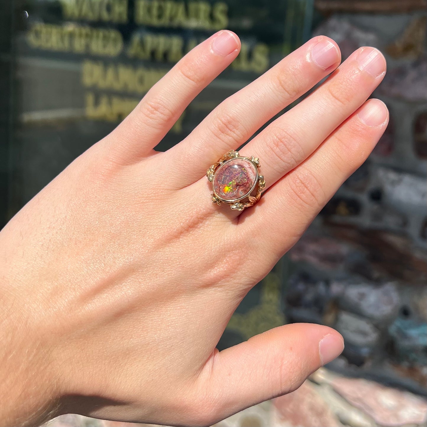 A ladies' estate yellow gold solitaire ring set with an oval cabochon cut natural Cantera fire opal.