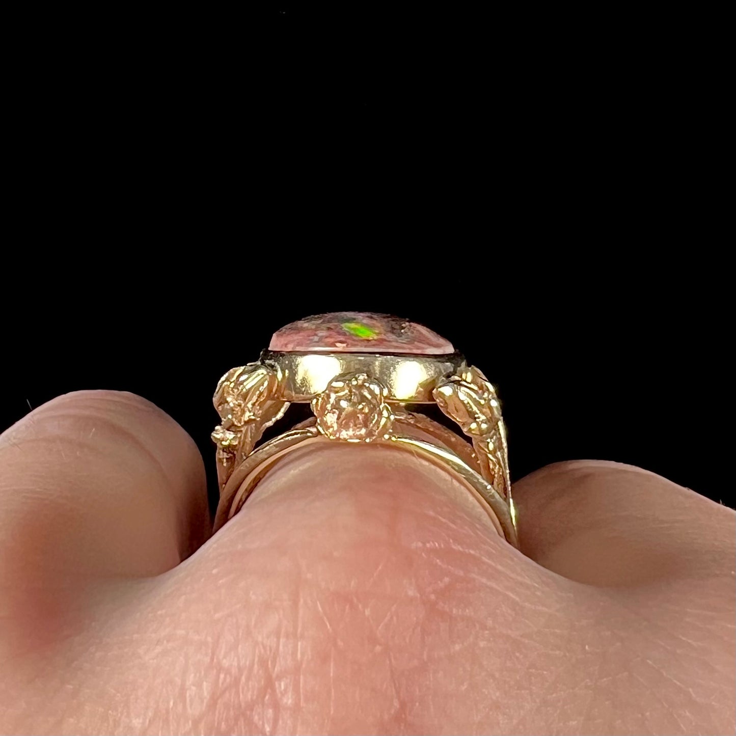 A ladies' estate yellow gold solitaire ring set with an oval cabochon cut natural Cantera fire opal.