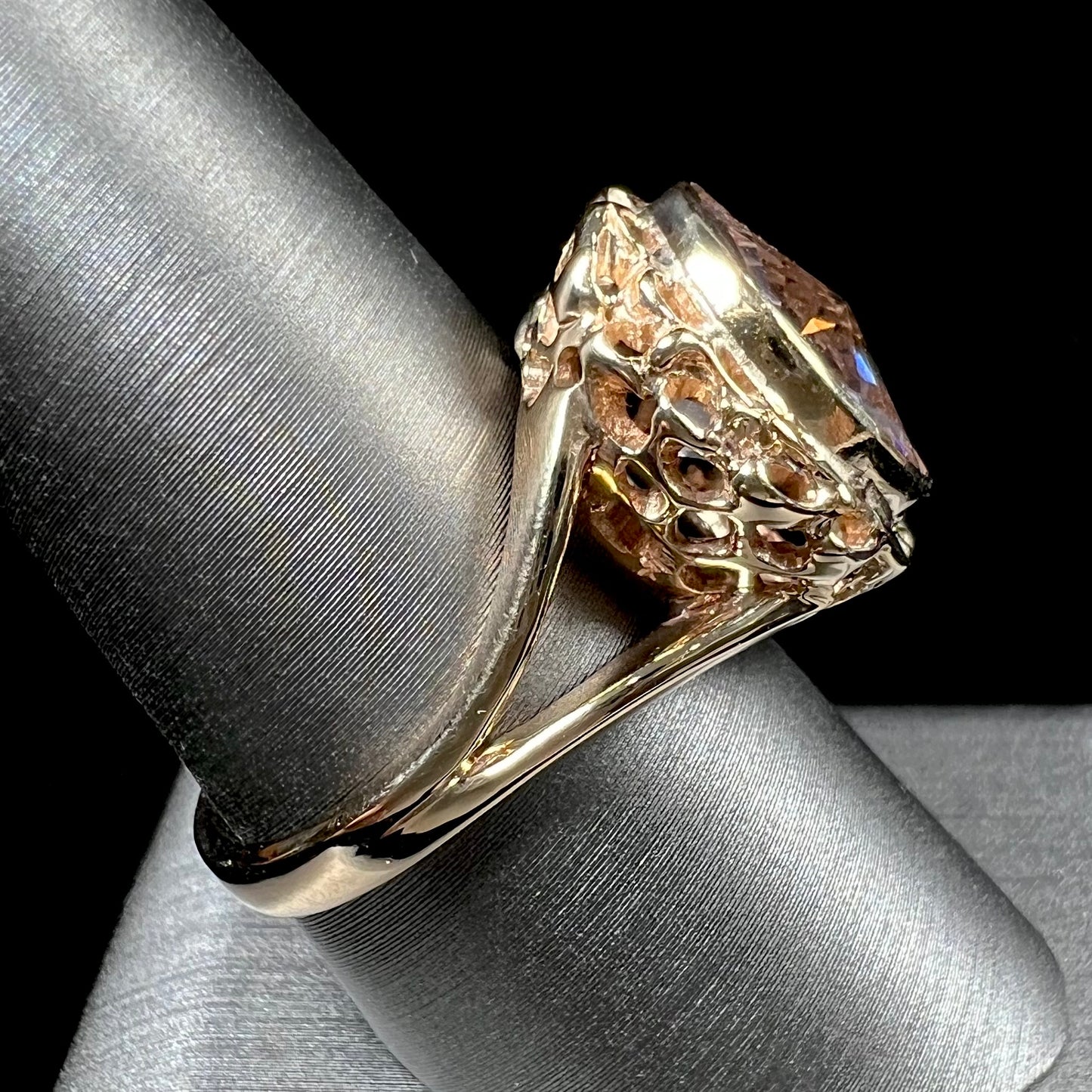 A ladies' yellow gold solitaire ring bezel set with a modified bud cut morganite gemstone.