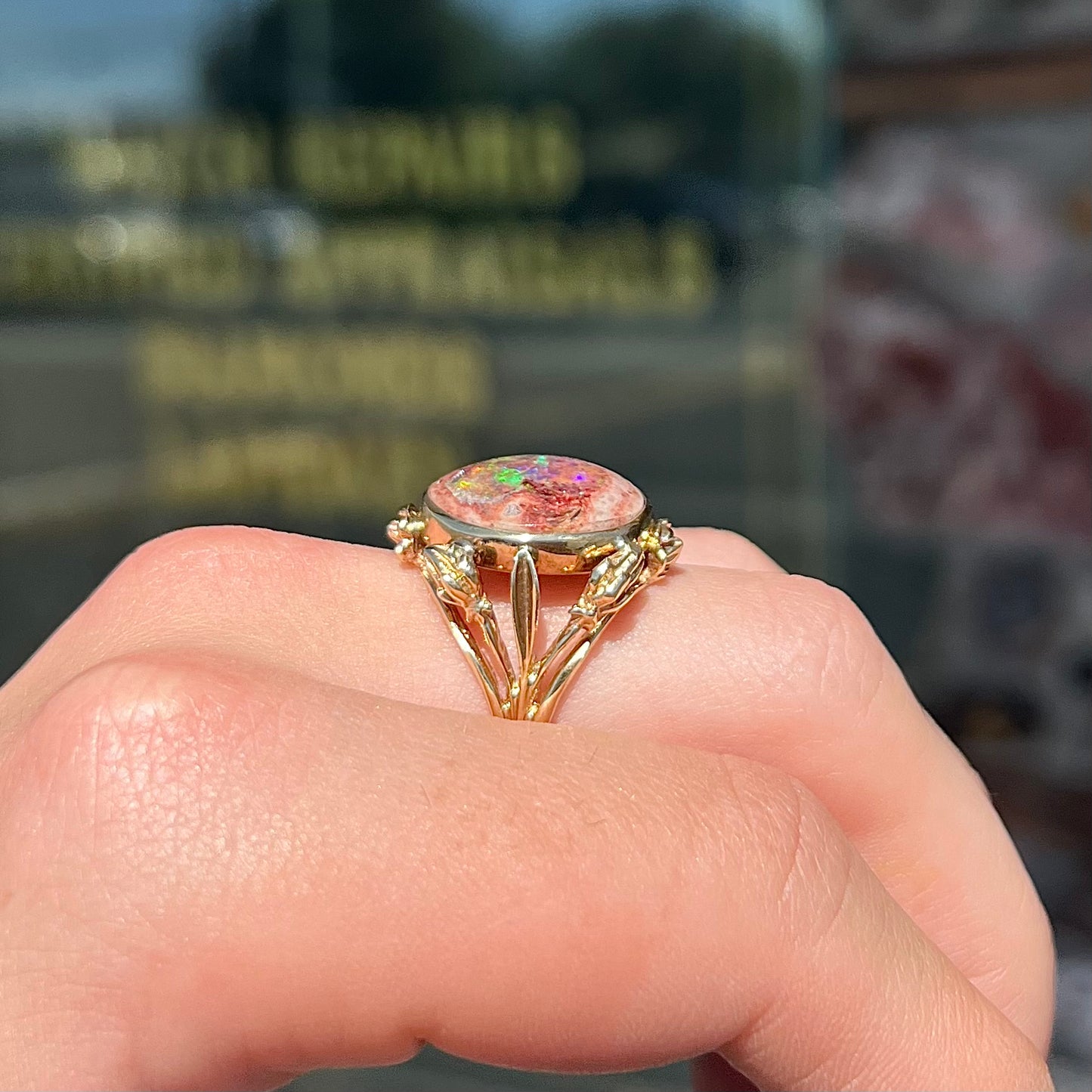 A ladies' estate yellow gold solitaire ring set with an oval cabochon cut natural Cantera fire opal.