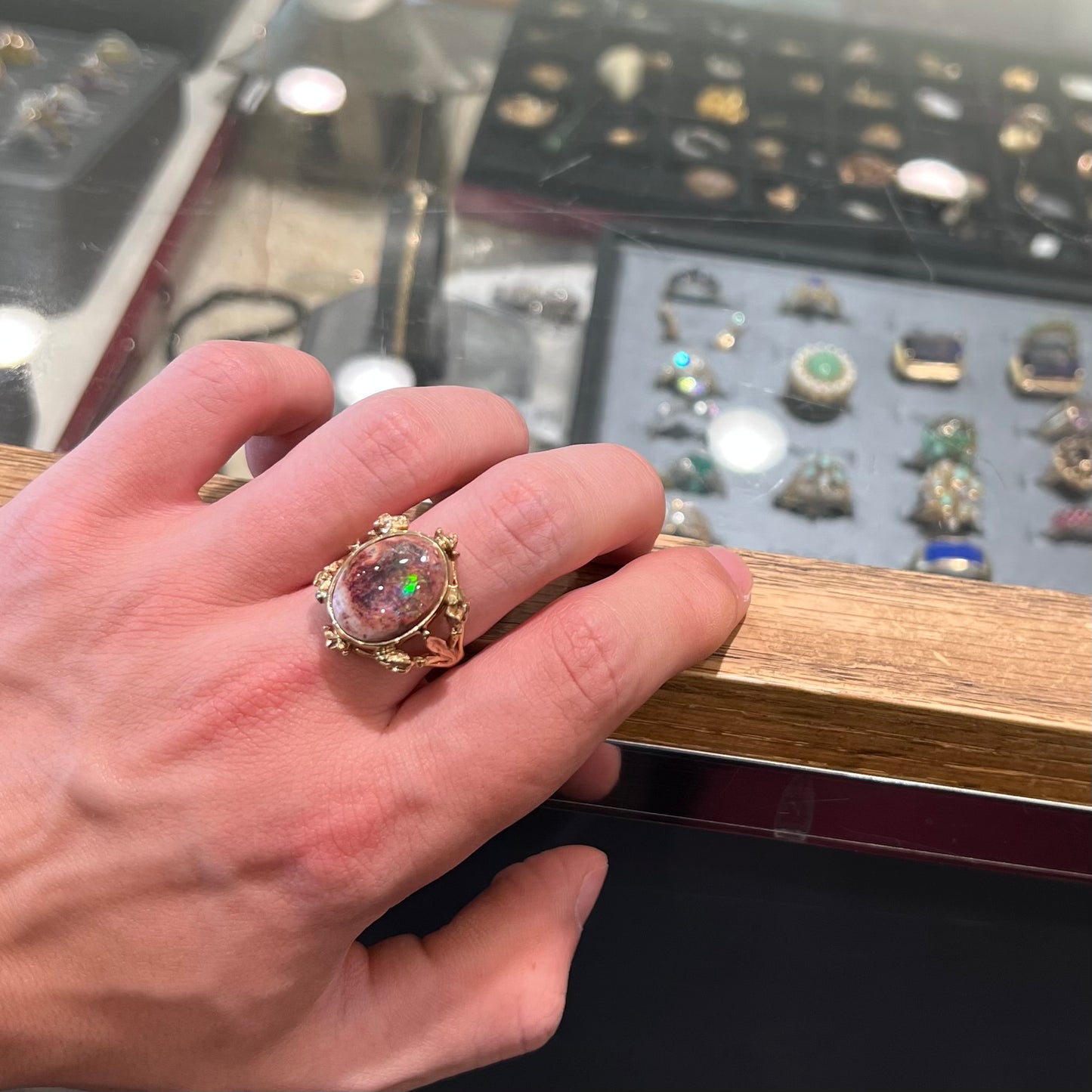 A ladies' estate yellow gold solitaire ring set with an oval cabochon cut natural Cantera fire opal.