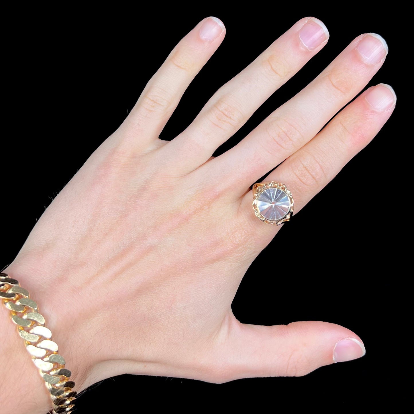 A ladies' yellow gold solitaire ring bezel set with a modified bud cut morganite gemstone.