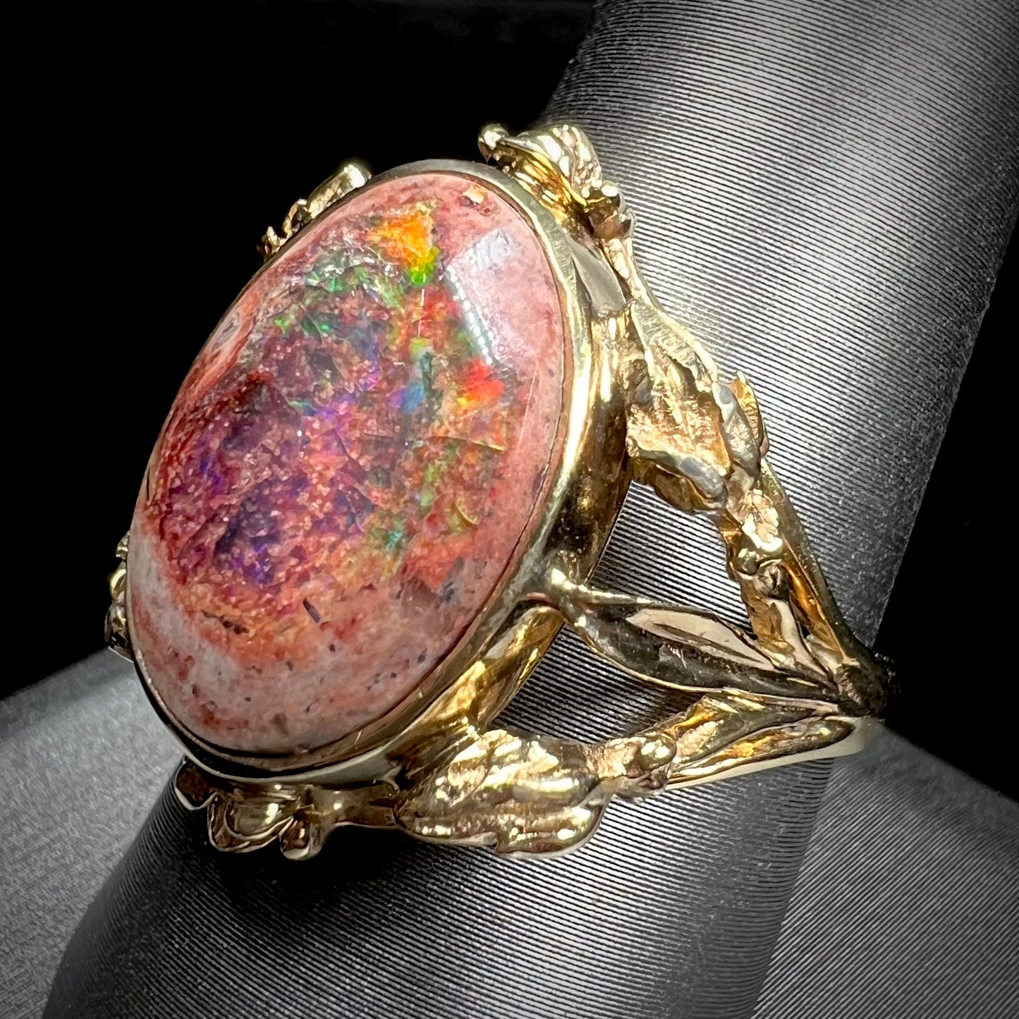 A ladies' estate yellow gold solitaire ring set with an oval cabochon cut natural Cantera fire opal.
