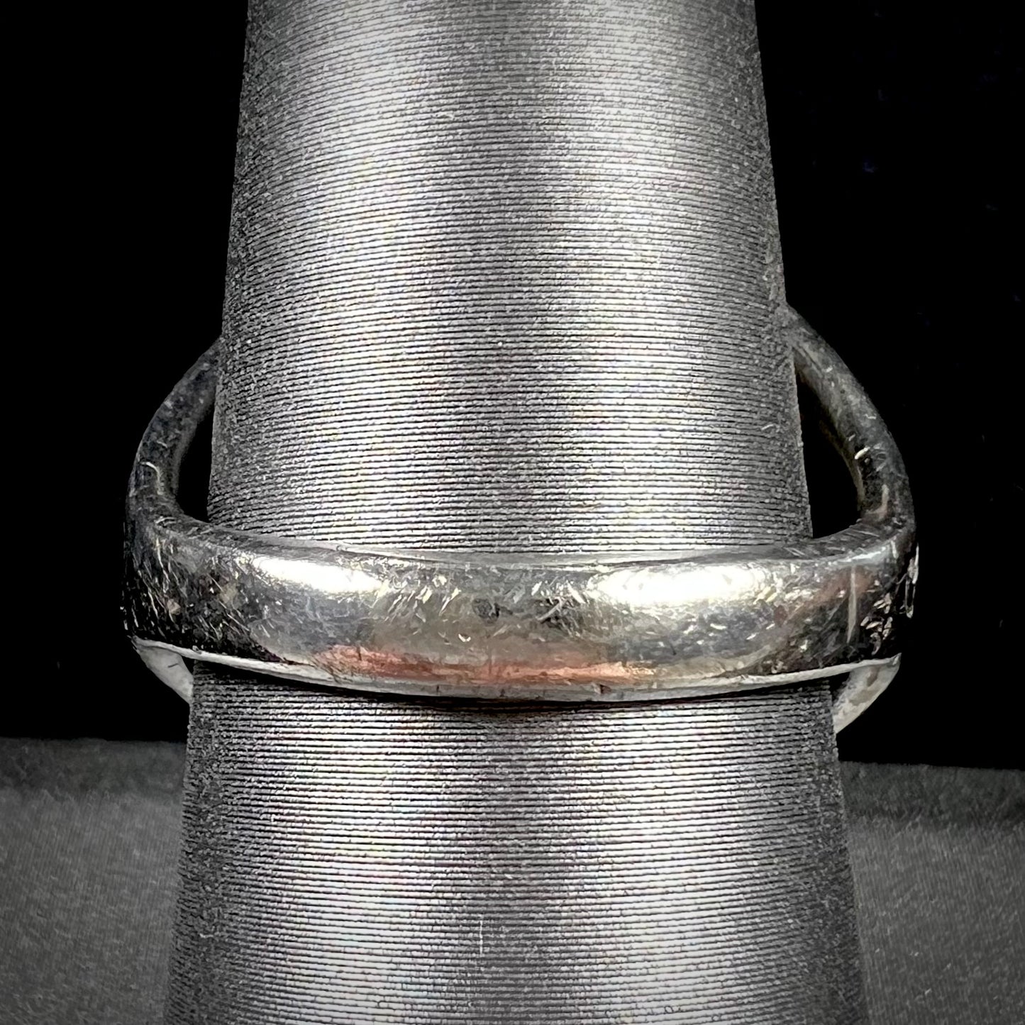 A men's sterling silver Morenci turquoise solitaire ring. The ring has a Southwest Navajo style stamp pattern.