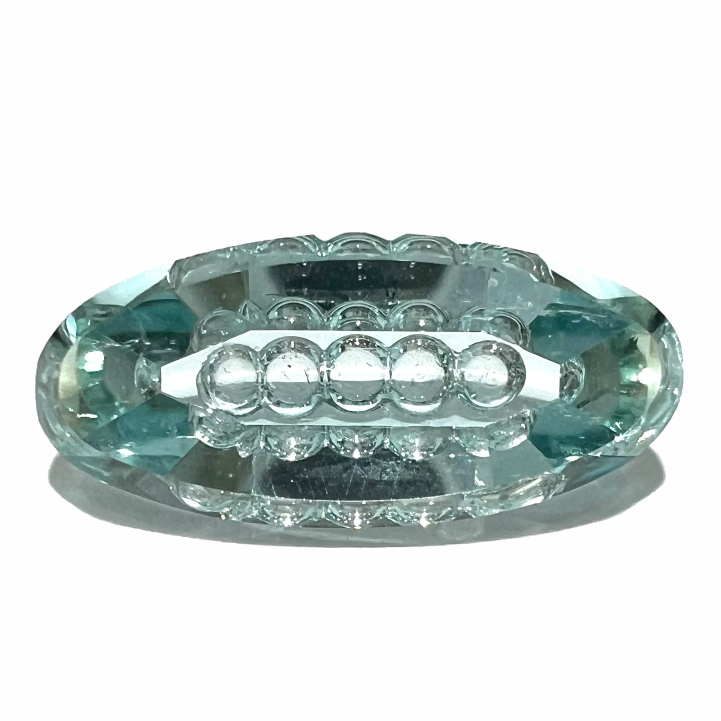 An oval fantasy cut greenish blue aquamarine stone cut by gem carver, Arthur Lee Anderson.
