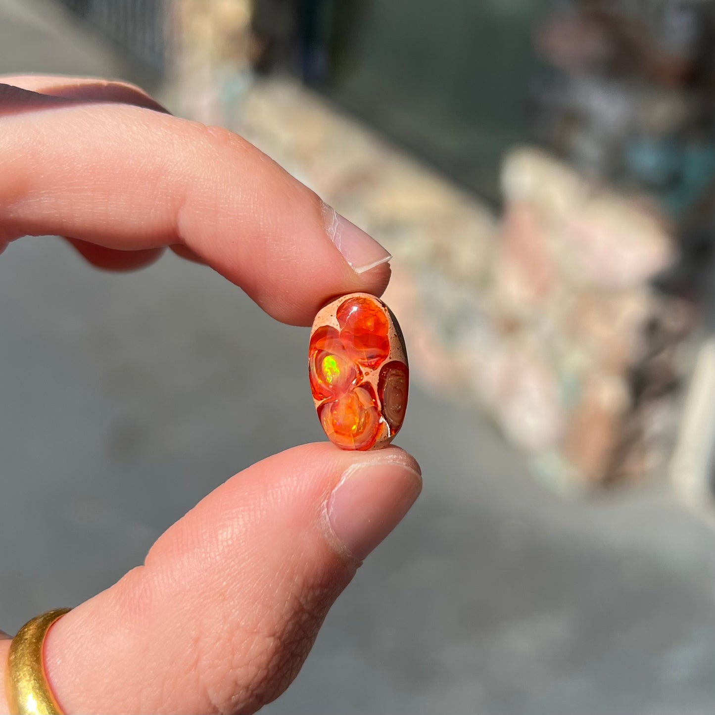 A loose Mexican matrix fire opal stone. The opal is orange with green flashes.