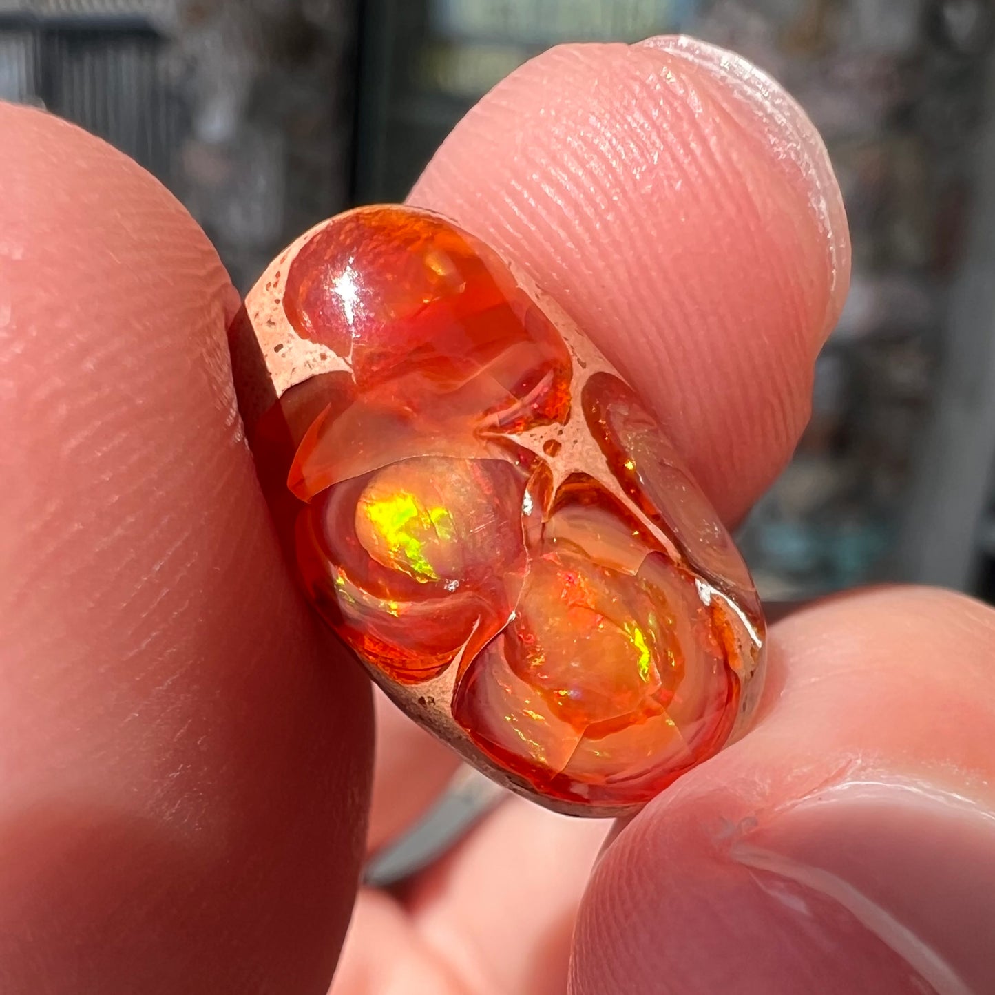 A loose Mexican matrix fire opal stone. The opal is orange with green flashes.