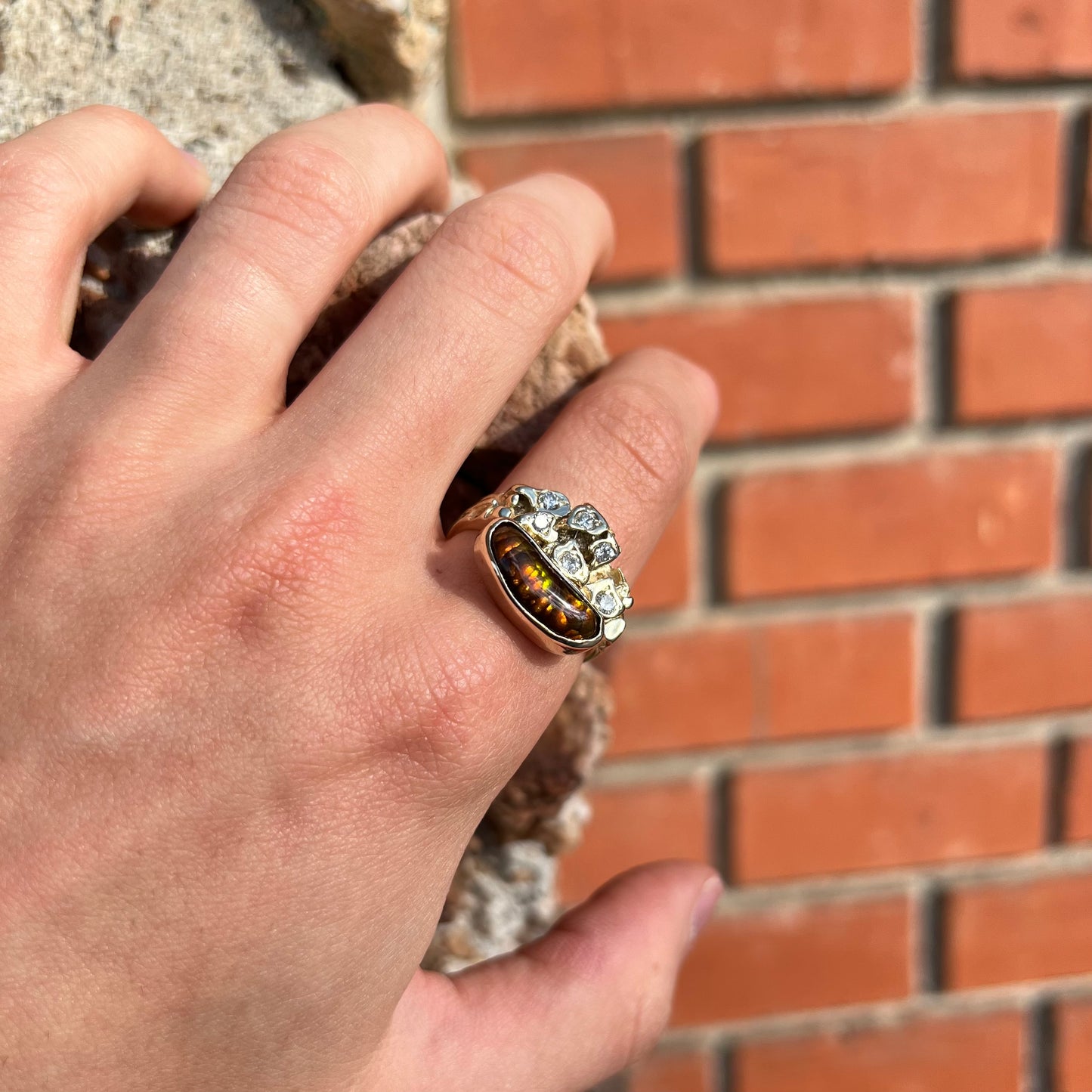 A ladies' nugget style yellow gold Mexican fire agate and diamond ring.