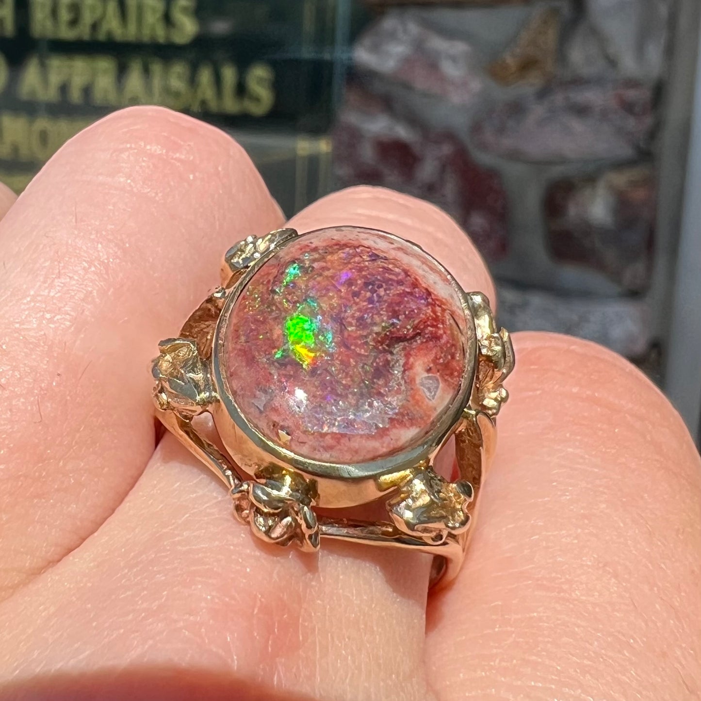 A ladies' estate yellow gold solitaire ring set with an oval cabochon cut natural Cantera fire opal.