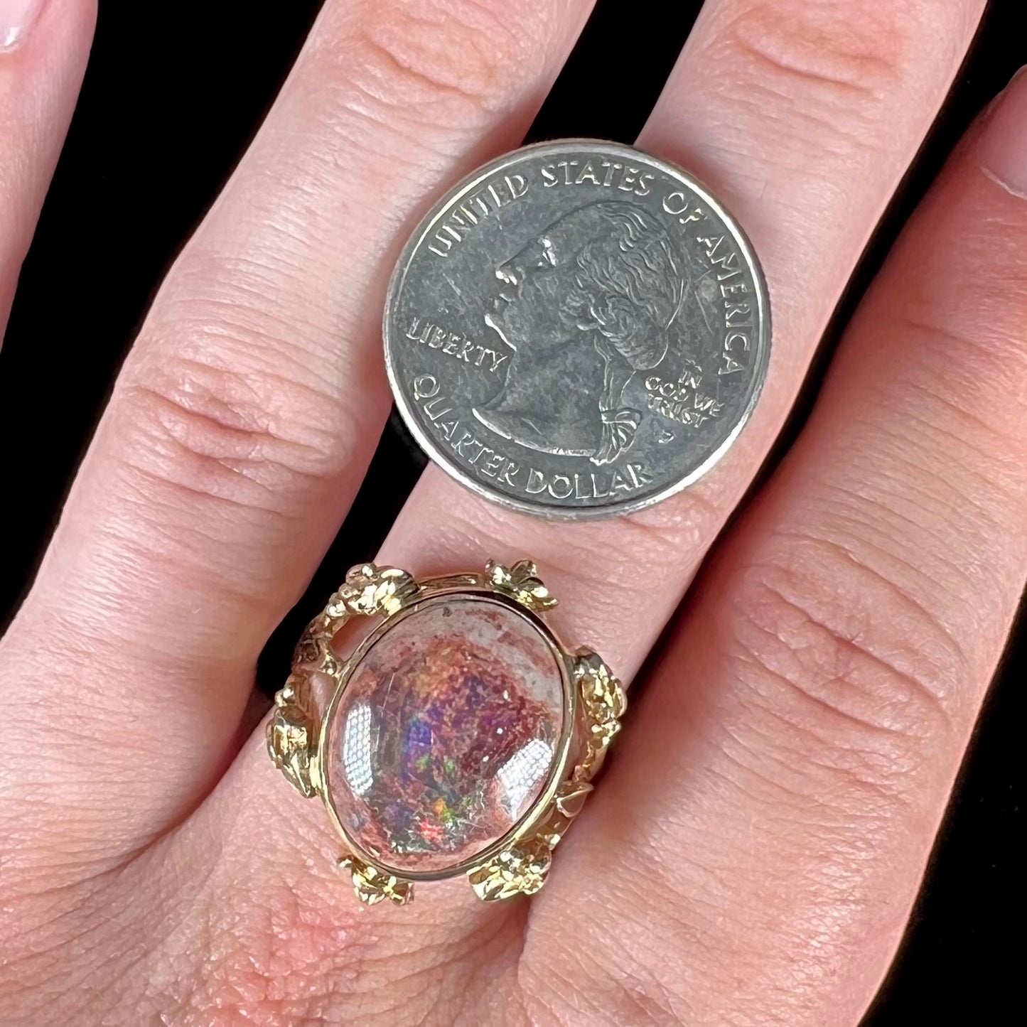A ladies' estate yellow gold solitaire ring set with an oval cabochon cut natural Cantera fire opal.