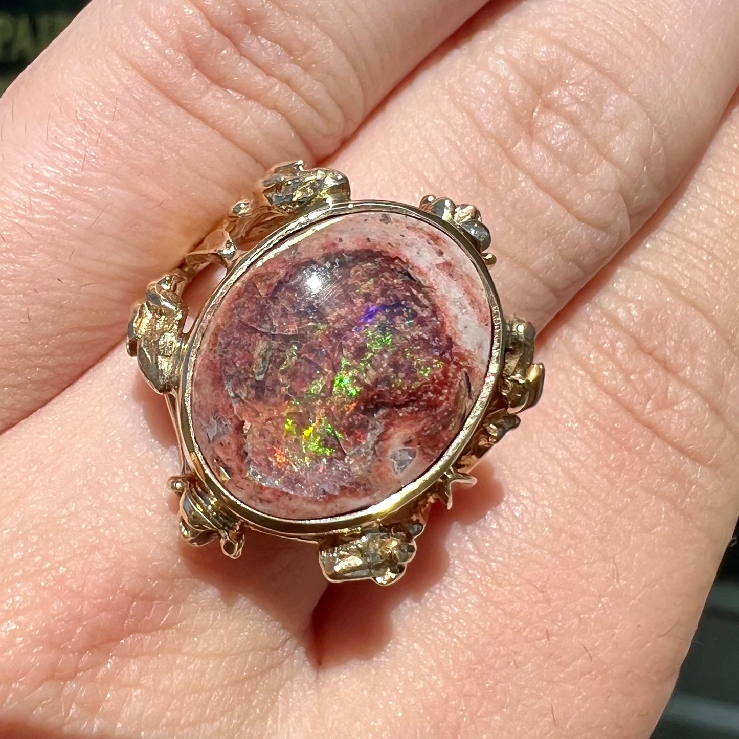 A ladies' estate yellow gold solitaire ring set with an oval cabochon cut natural Cantera fire opal.