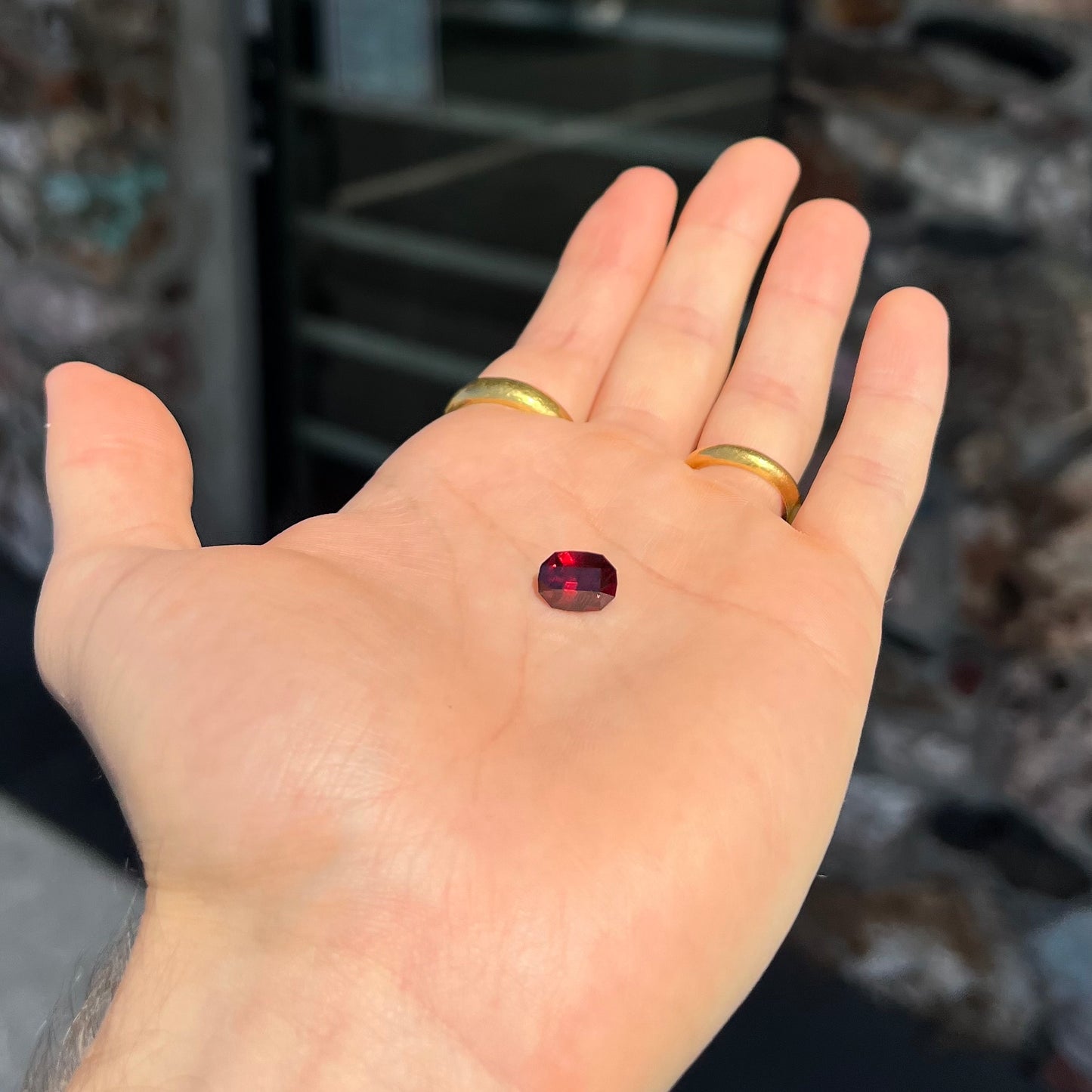 A loose, octagon cut rhodolite garnet gemstone. The stone is a deep, purplish crimson red color.