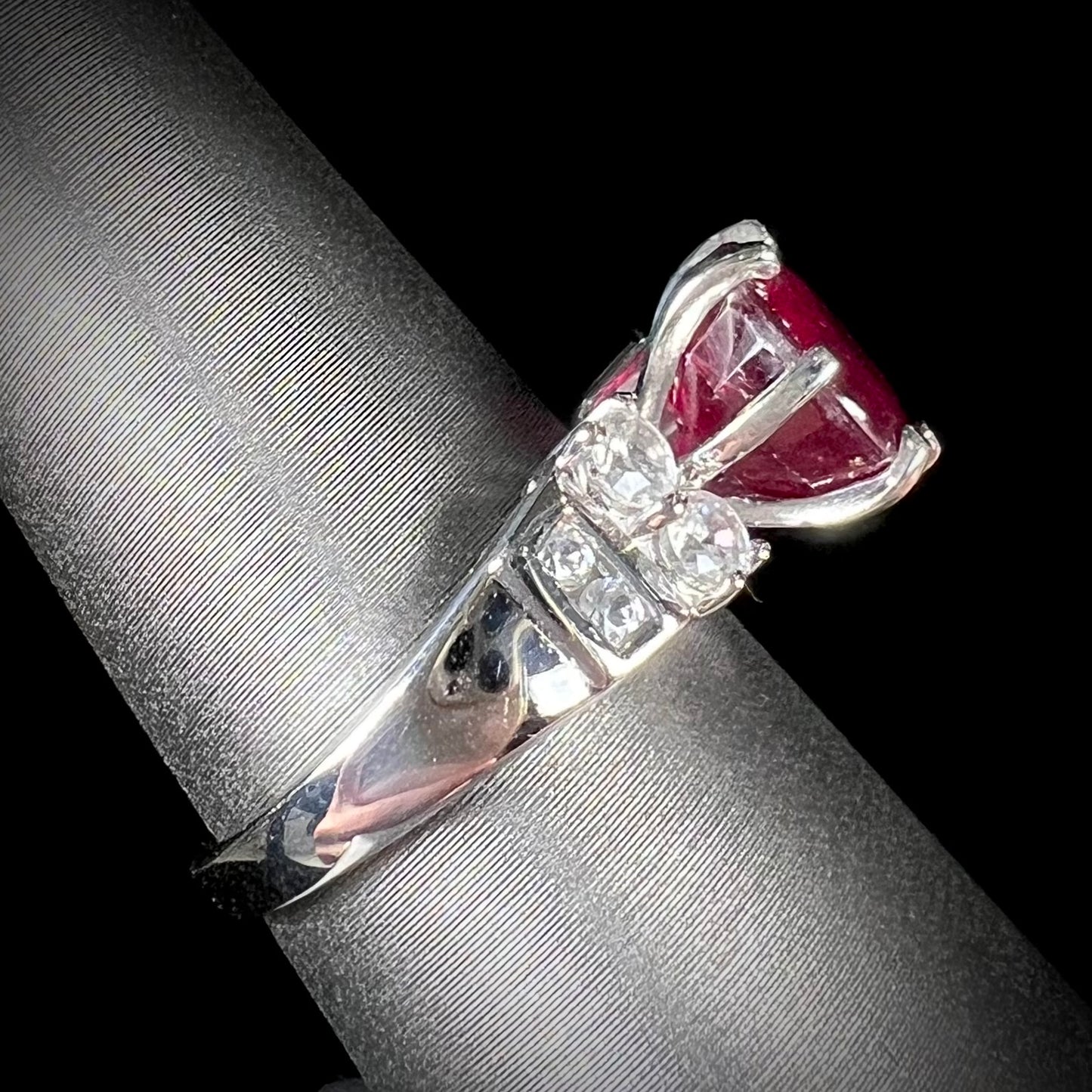 A ladies' sterling silver natural ruby and white zircon ring. The real ruby is glass filled.
