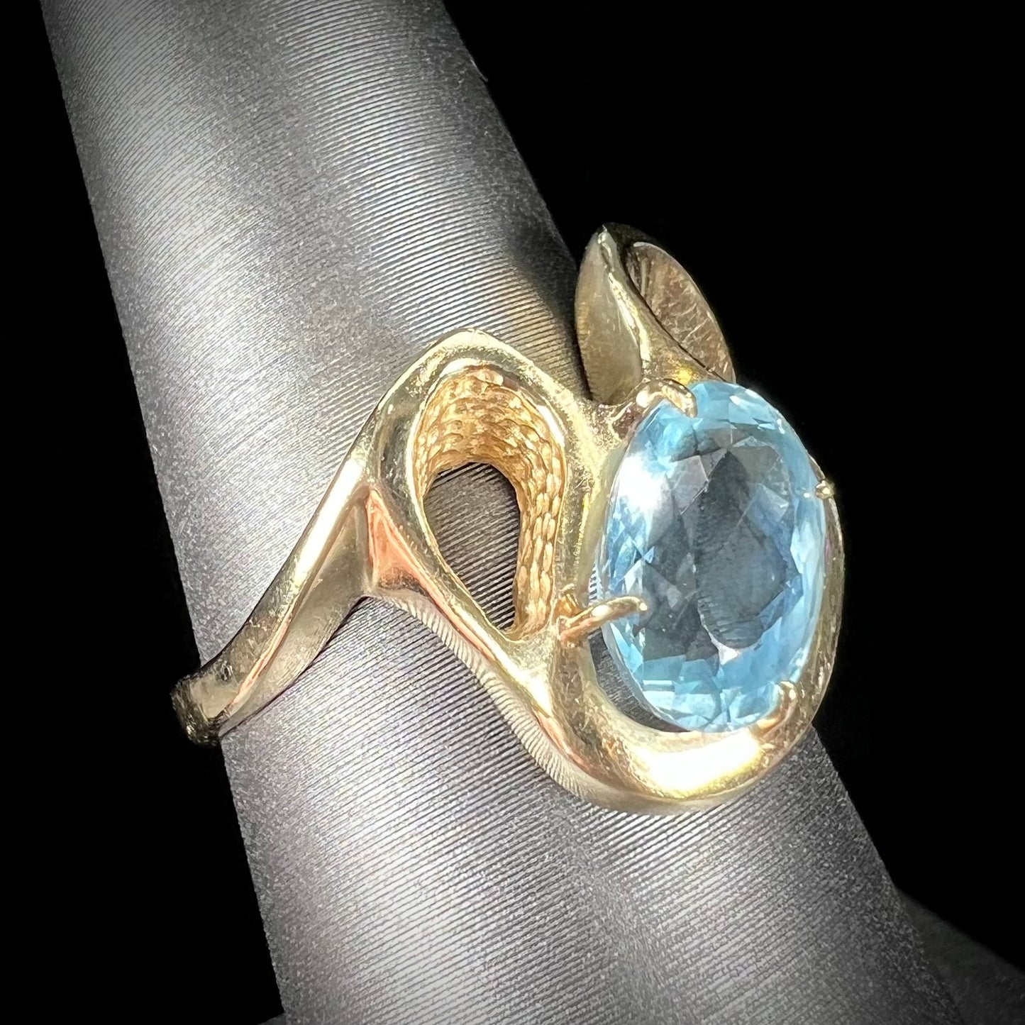 A ladies' estate yellow gold aquamarine solitaire ring. The aquamarine is oval cut.