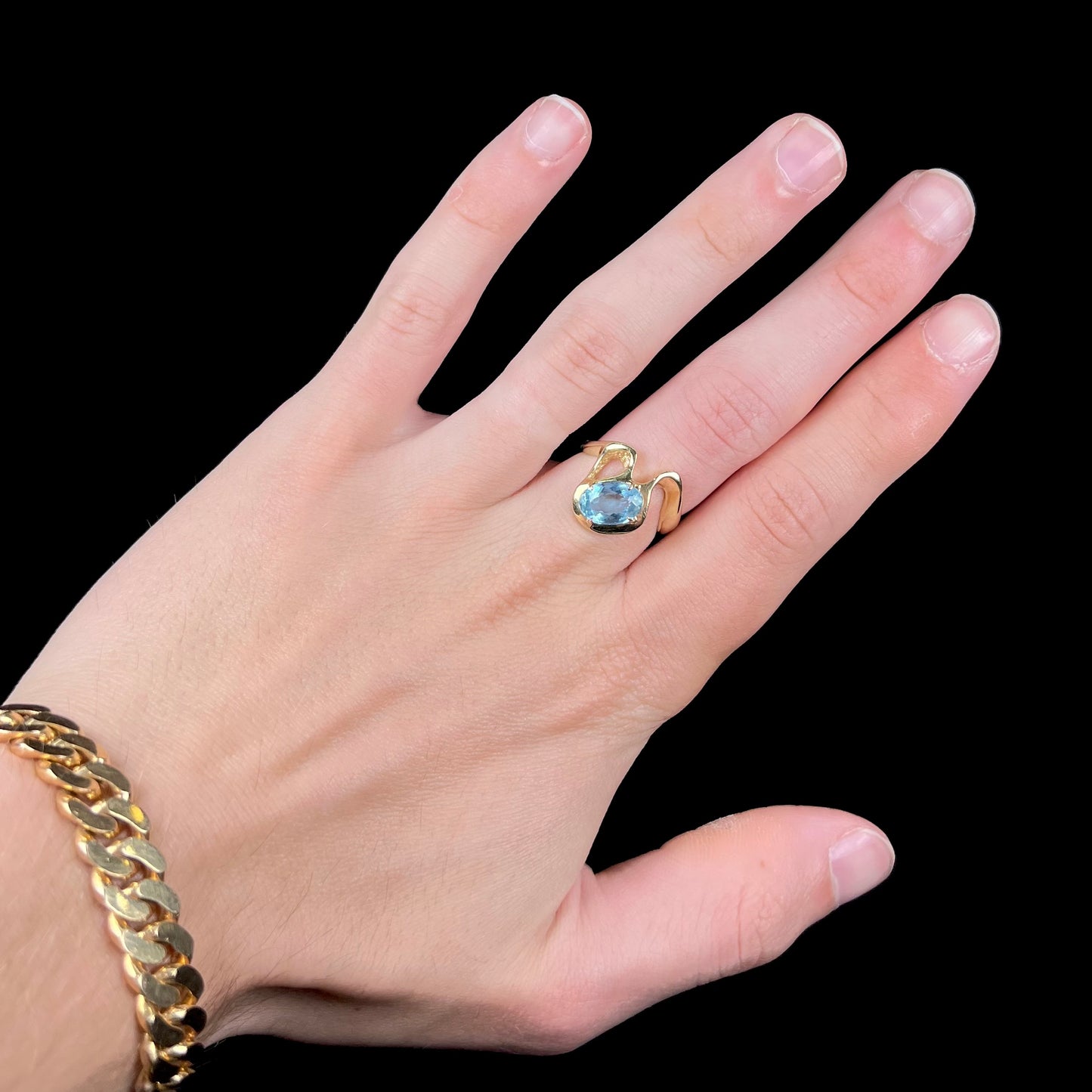 A ladies' estate yellow gold aquamarine solitaire ring. The aquamarine is oval cut.