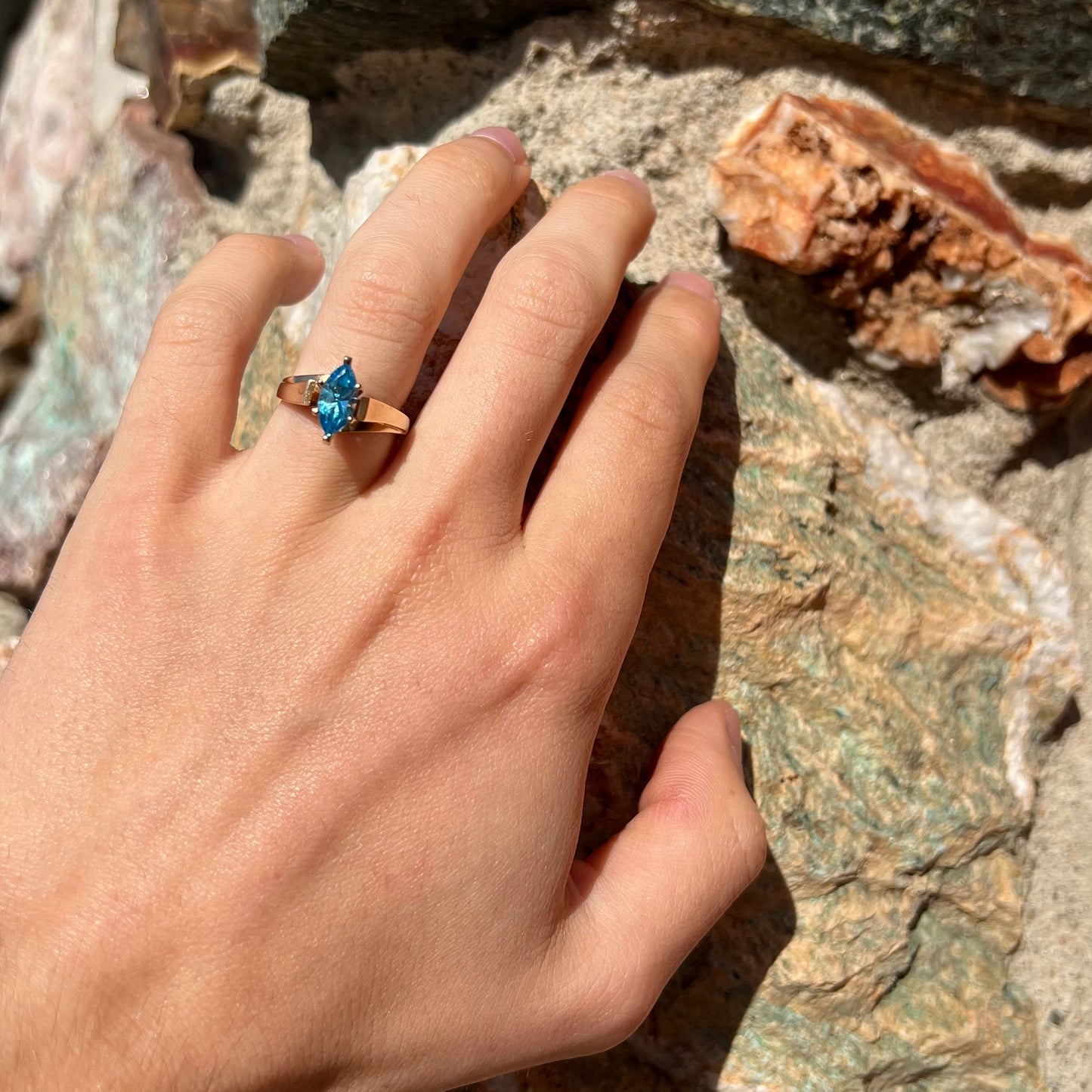 A ladies' estate yellow gold ring, prong set with a marquise cut blue topaz stone. There are scratches on the shank.