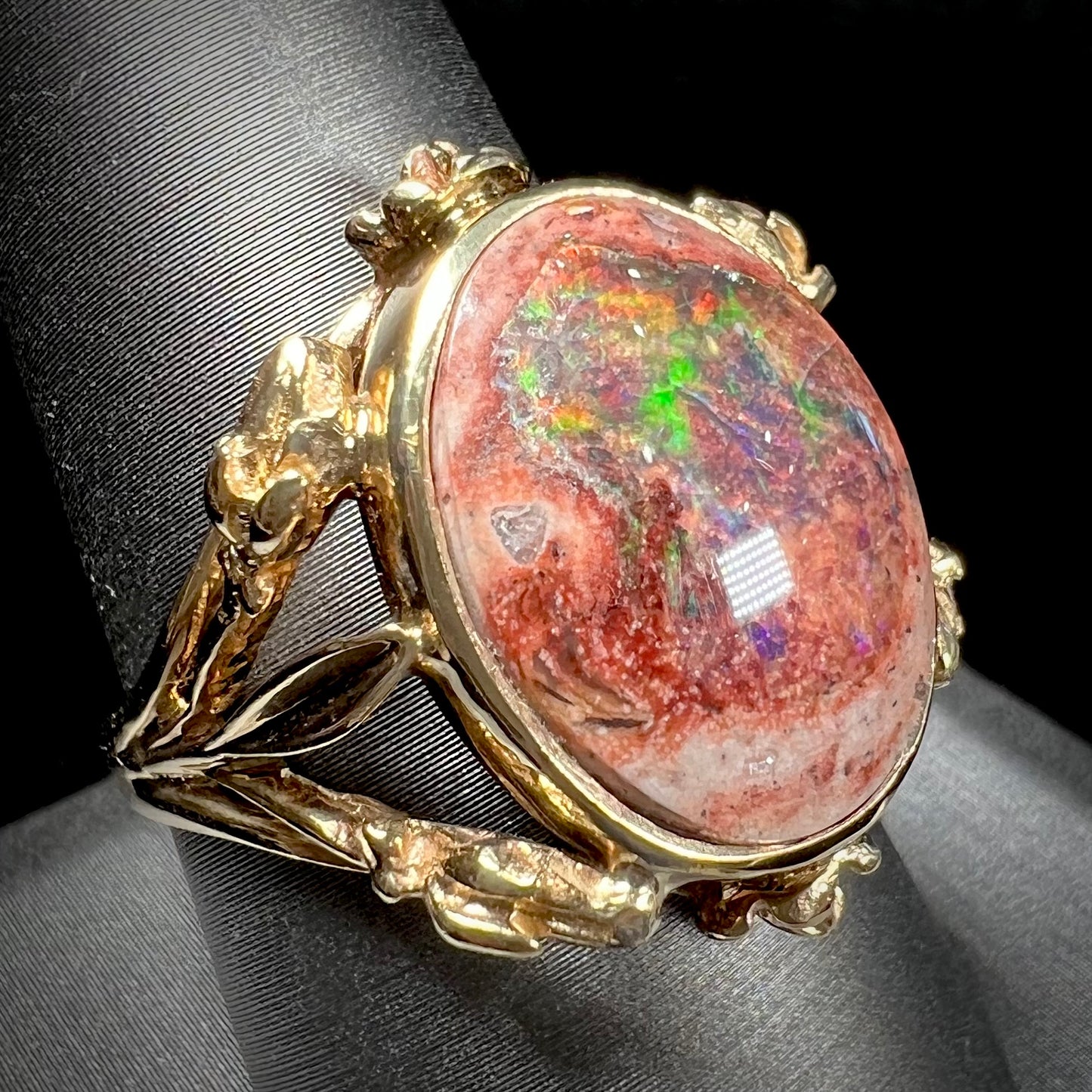 A ladies' estate yellow gold solitaire ring set with an oval cabochon cut natural Cantera fire opal.