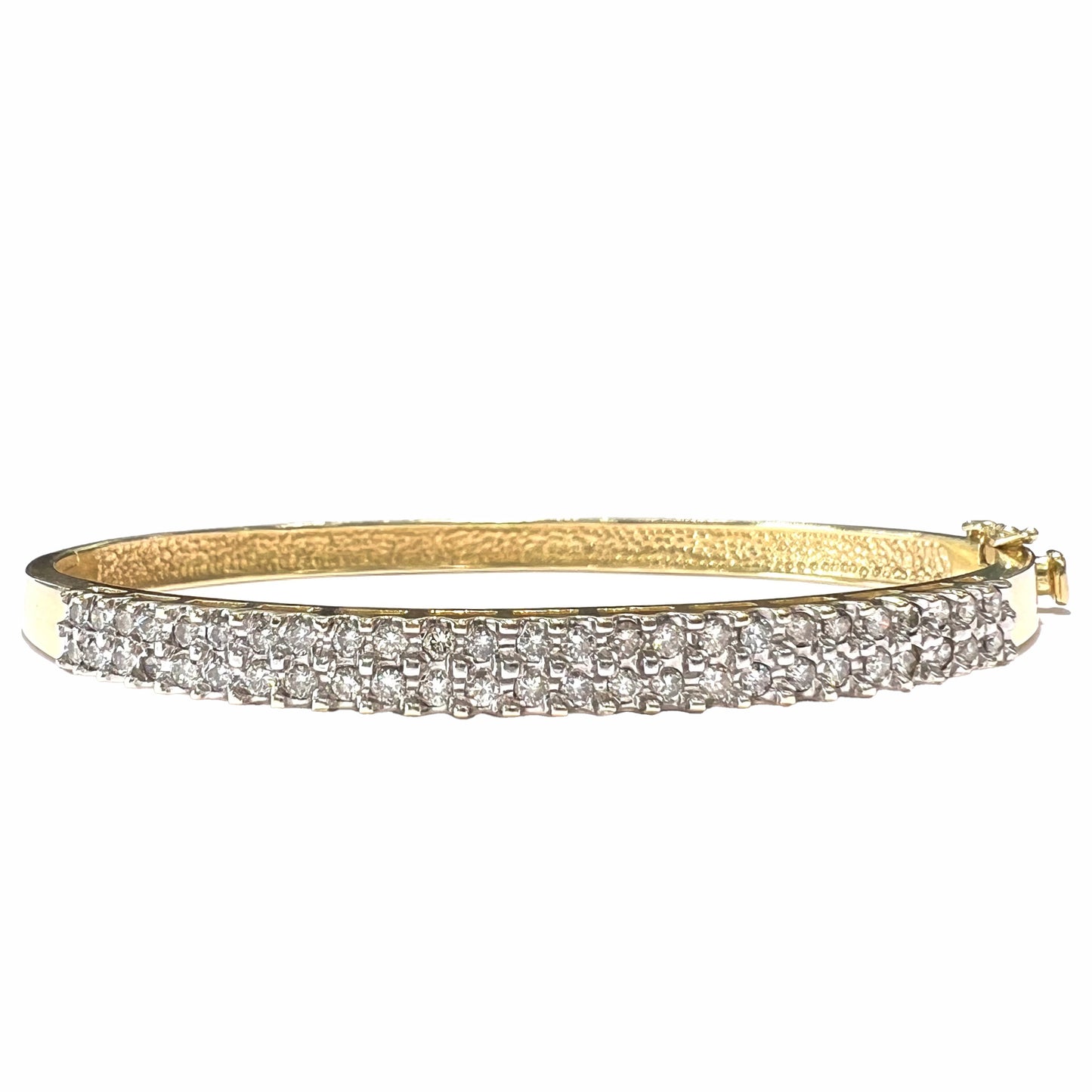 A ladies' hinged yellow gold bangle bracelet set with 50 Standard Round Brilliant Cut diamonds.