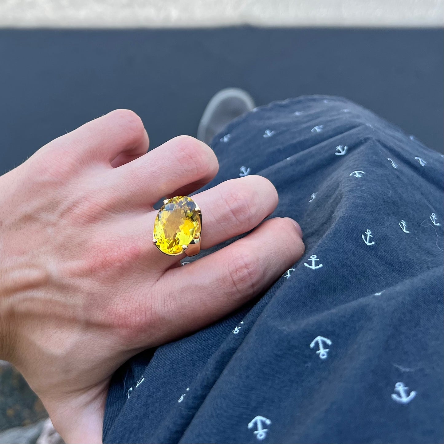 An 18 karat yellow gold solitaire cocktail ring set with a faceted oval cut golden beryl gemstone.