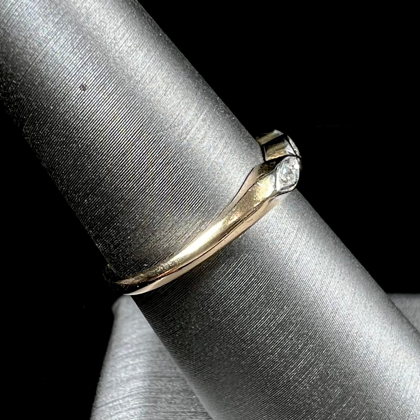 A vintage, yellow gold ladies' wedding band set with three single cut diamonds in marquise shaped designs.