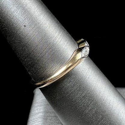 A vintage, yellow gold ladies' wedding band set with three single cut diamonds in marquise shaped designs.