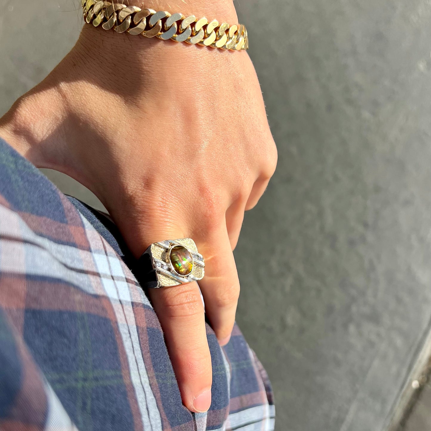 A yellow gold men's ring channel set with diamonds and bezel set with a Mexican fire agate stone.