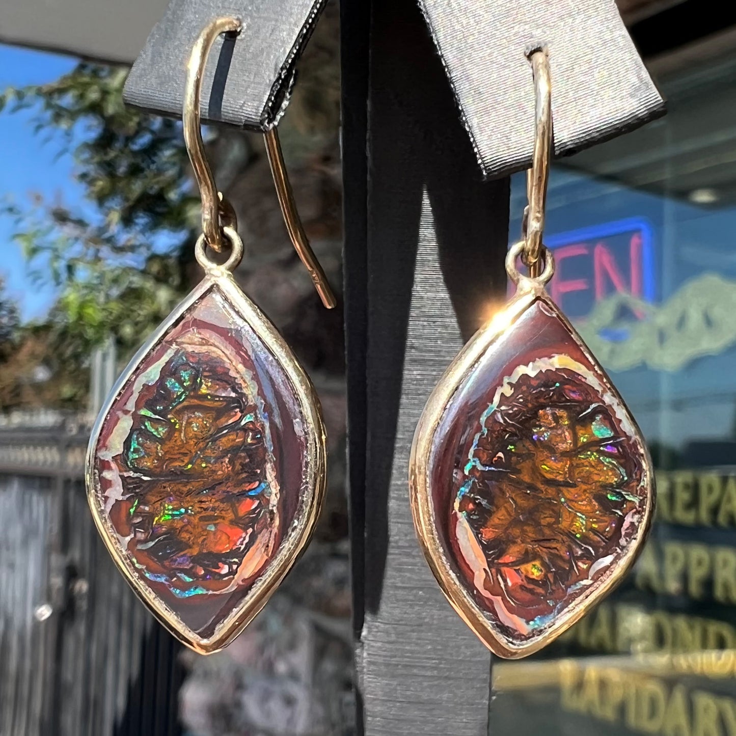 A pair of yellow gold dangle earrings bezel set with natural boulder opals from Koroit, Australia.