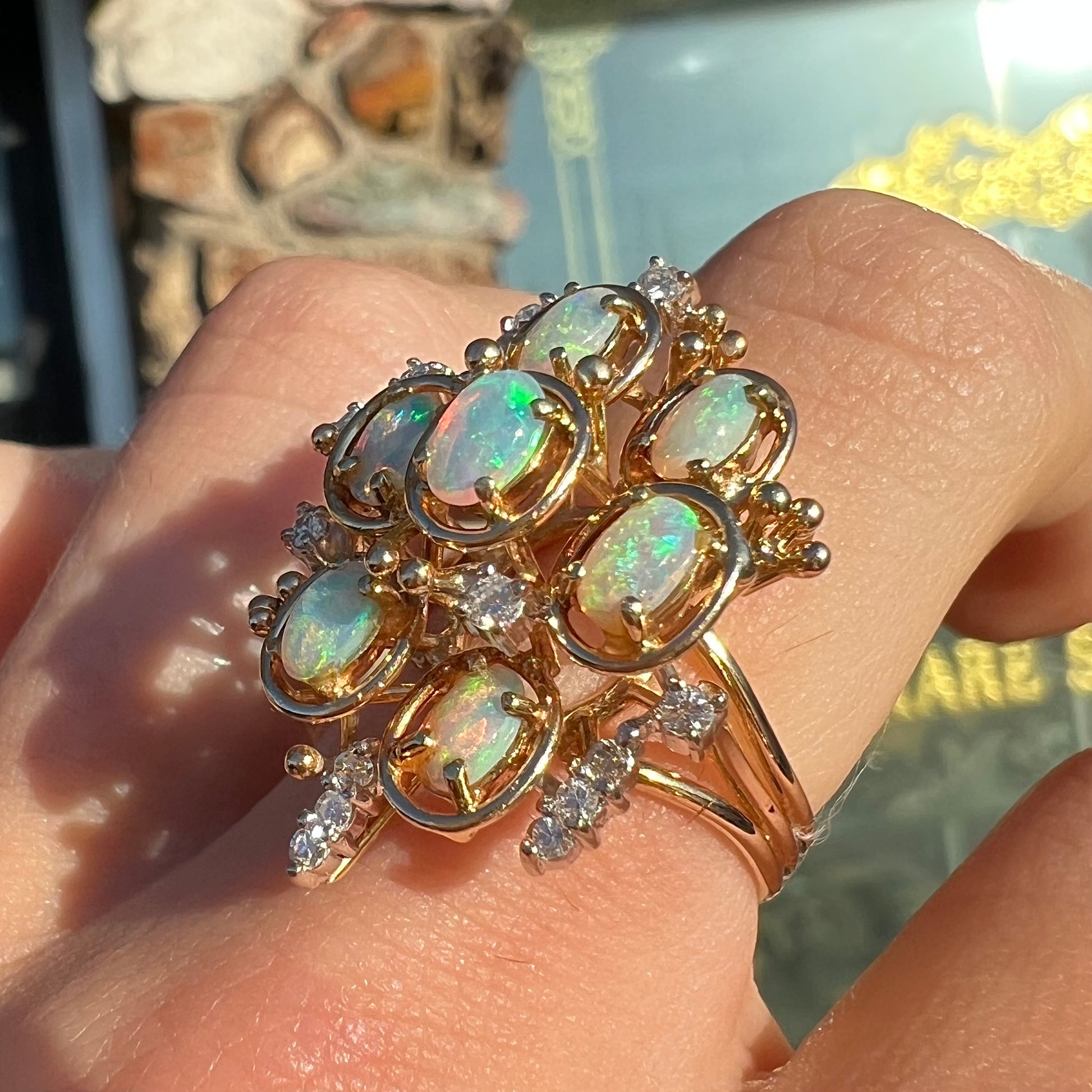 A ladies' vintage mid-century modern style opal and diamond cluster ring in yellow gold.