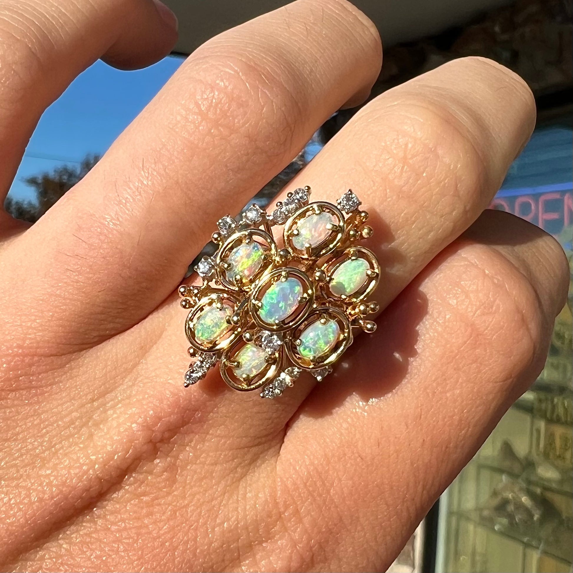 A ladies' vintage mid-century modern style opal and diamond cluster ring in yellow gold.