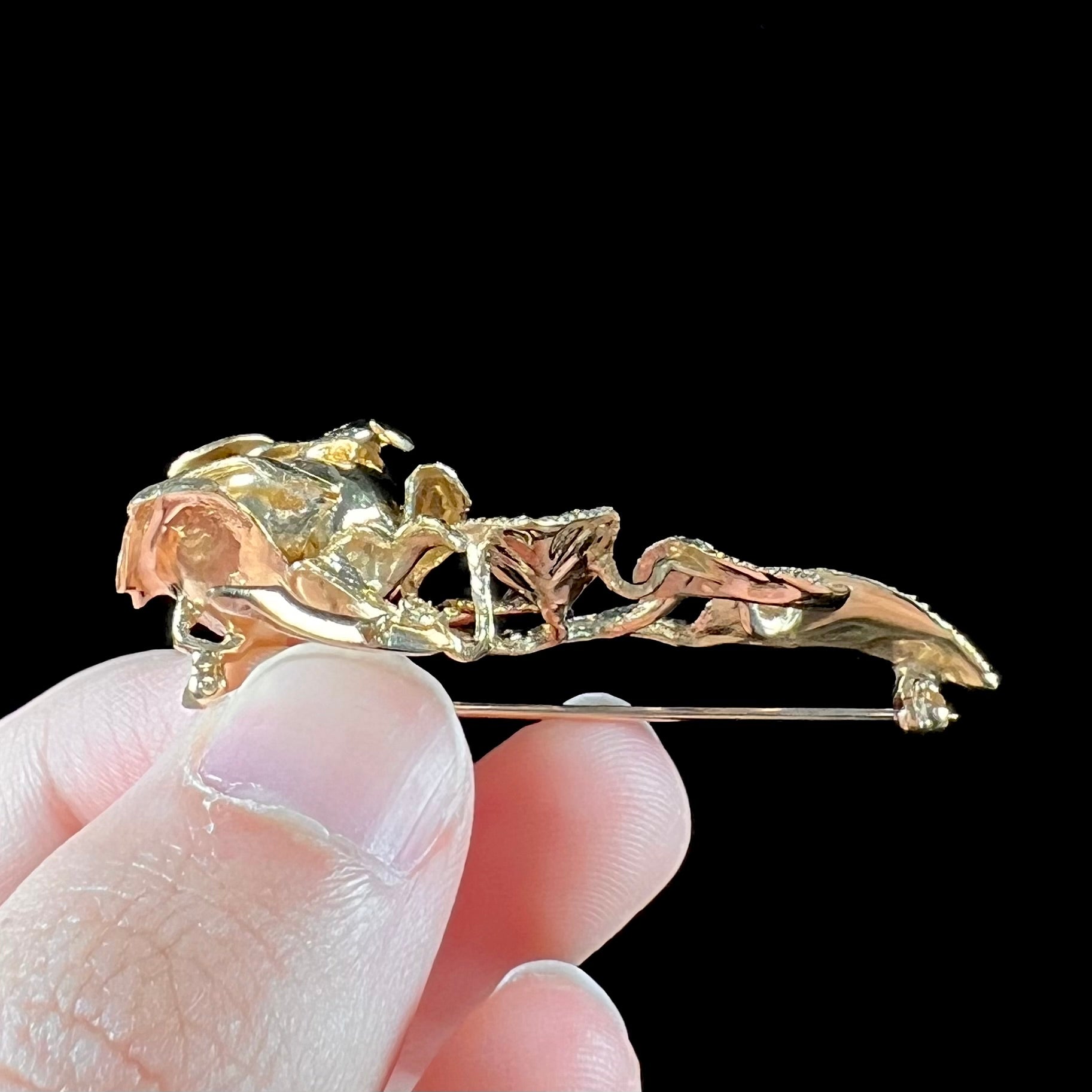 A vintage 14 karat yellow gold rose brooch.