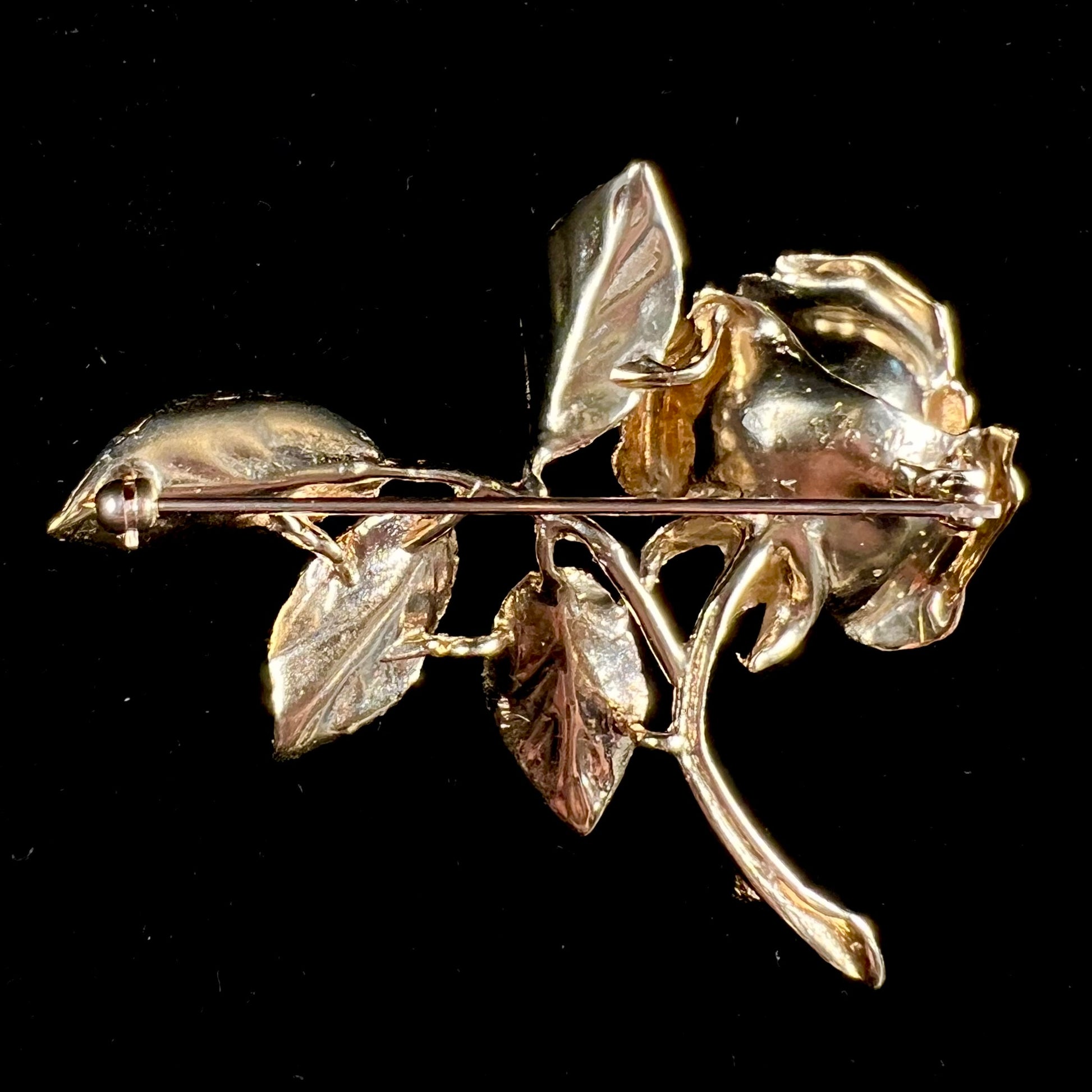 A vintage 14 karat yellow gold rose brooch.