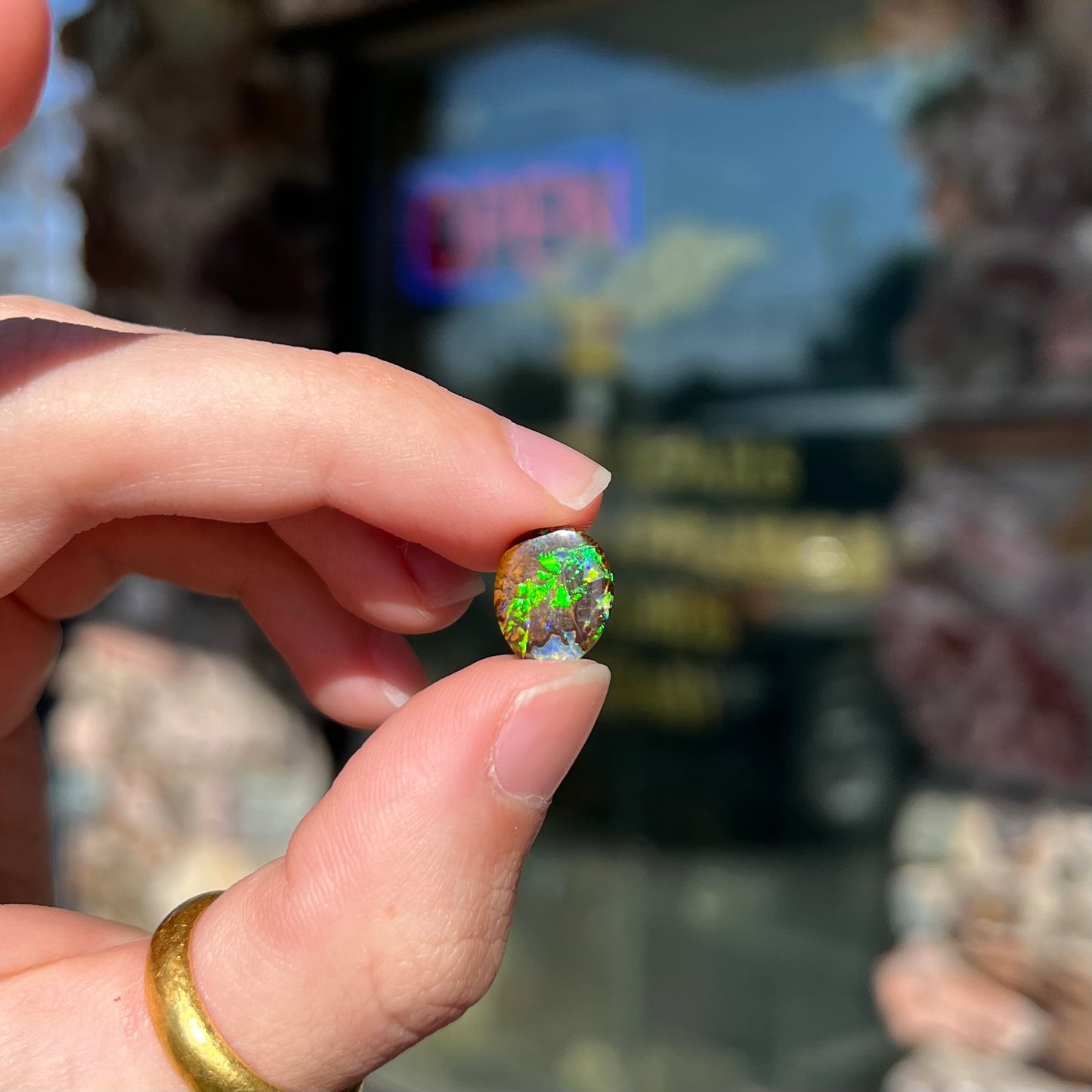 A bright green boulder opal stone from Koroit, Australia.
